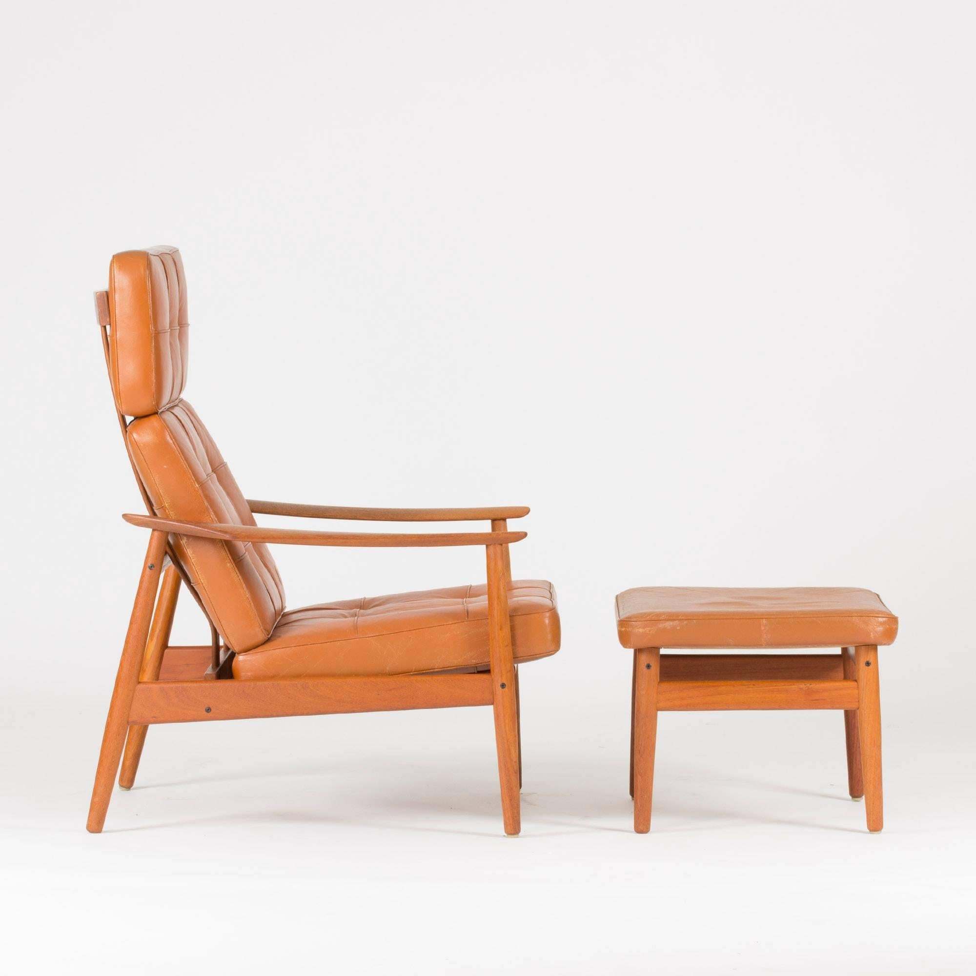 Teak and leather lounge chair with ottoman by Arne Vodder, made for relaxation. Beautifully carved armrests.