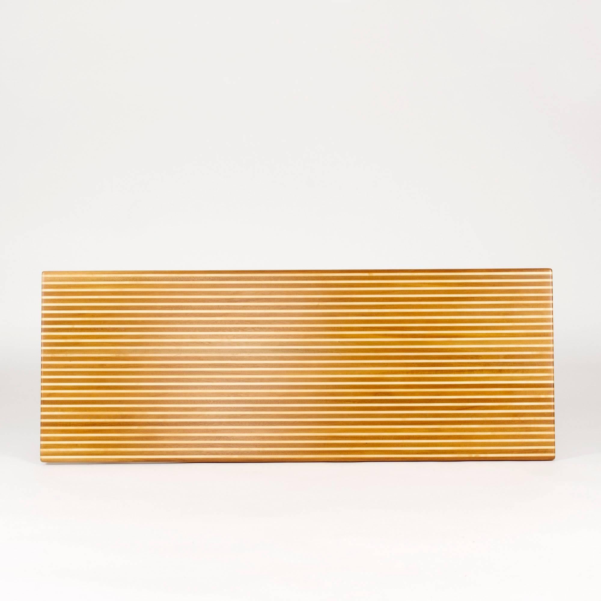 Amazing coffee table by Yngvar Sandström, in a striped pattern created by alternating teak and birch in the solid wood tabletop.