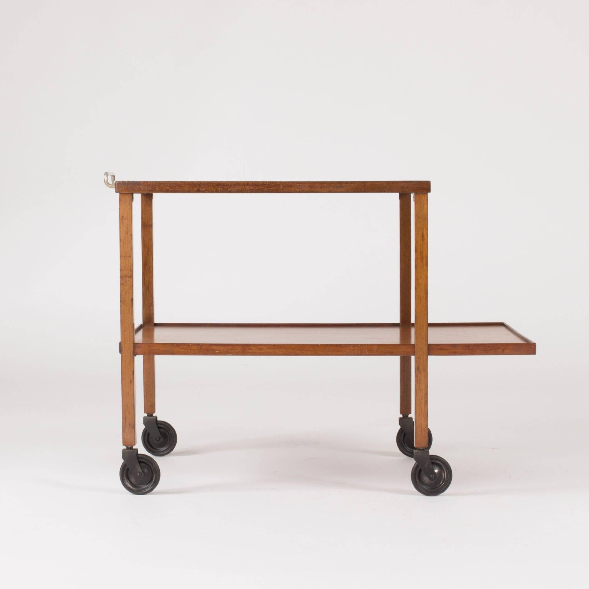 Mahogany bar trolley by Josef Frank. Simplistic to the core with a tempered Silhouette and great proportions. Steel handle.