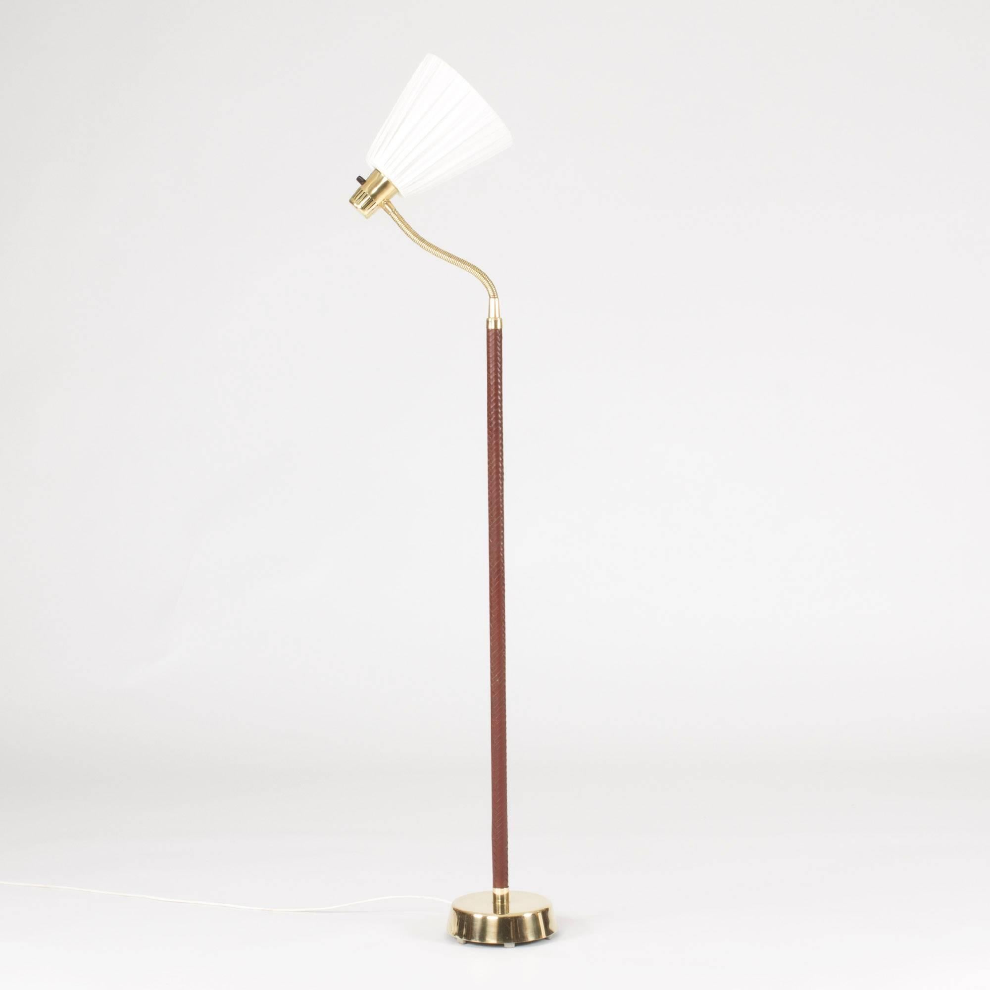 Elegant floor lamp by Hans Bergström with a flexible neck. Made from brass and luxurious, oxblood red wreathed leather along the pole.