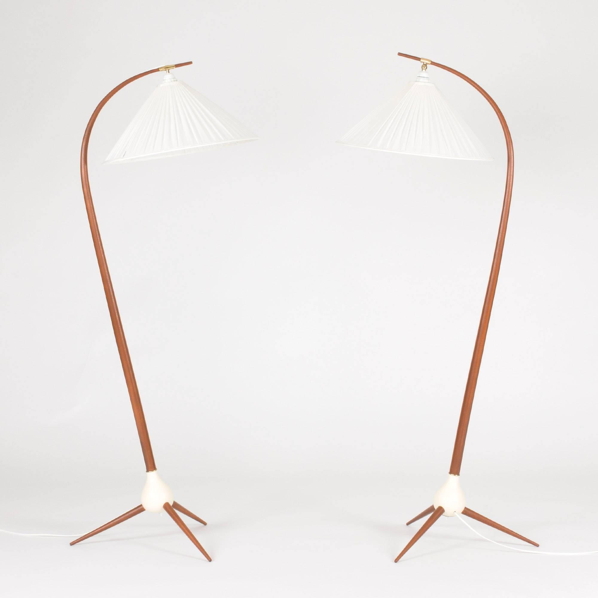 Pair of amazing floor lamps by Severin Hansen. The handles are made from teak bent into an elegant curve, with the wiring visible on the backs. The handles and three-legged bases are linked by an onion shaped wood form that is painted white. A rare,