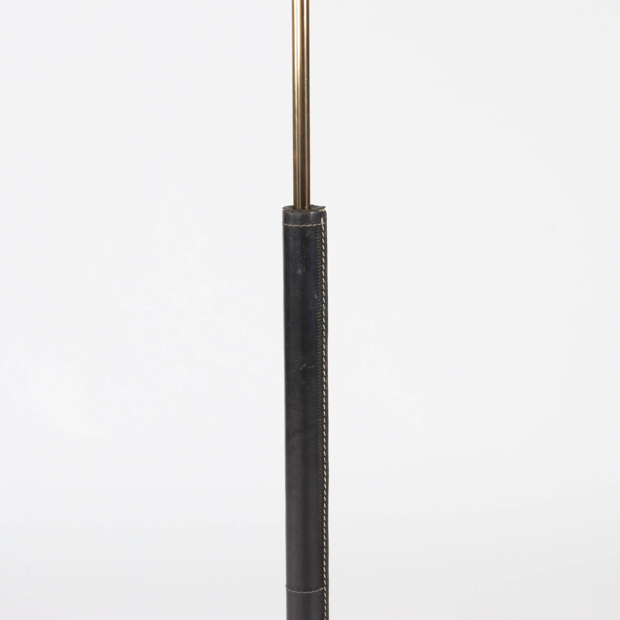 Cool floor lamp from Bergboms with a leather-clad brass pole and foot. Black leather with contrasting white seams.

Bergboms was a successful Swedish lighting firm which manufactured both own designs and those of international designers such as