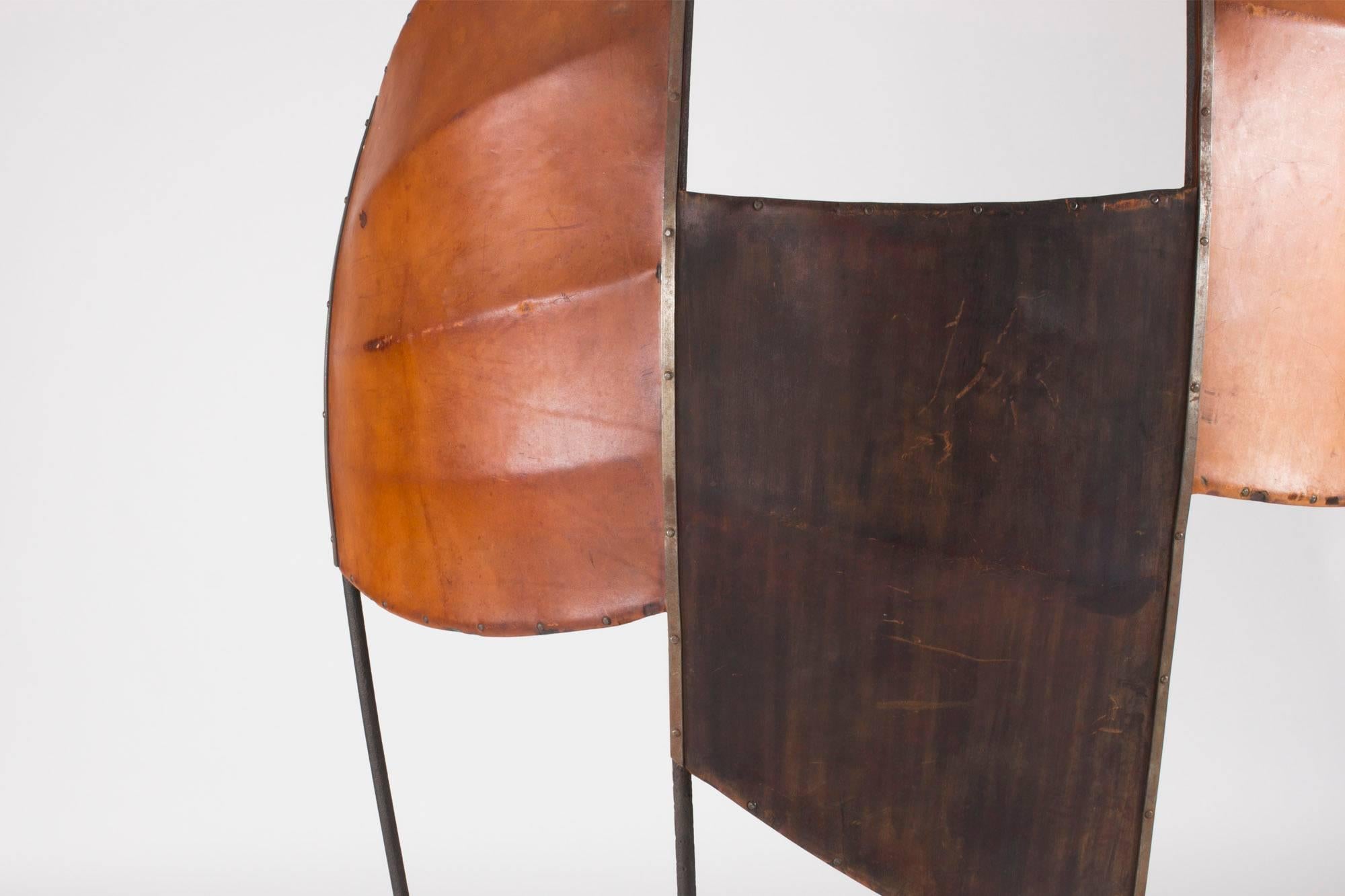 Spectacular sculptural room divider by Fred Leyman, custom-made for Majorna Library in Gothenburg in 1963. This piece is one of four that are each unique, made from wrought iron and hardened leather. The room dividers were granted substantial public