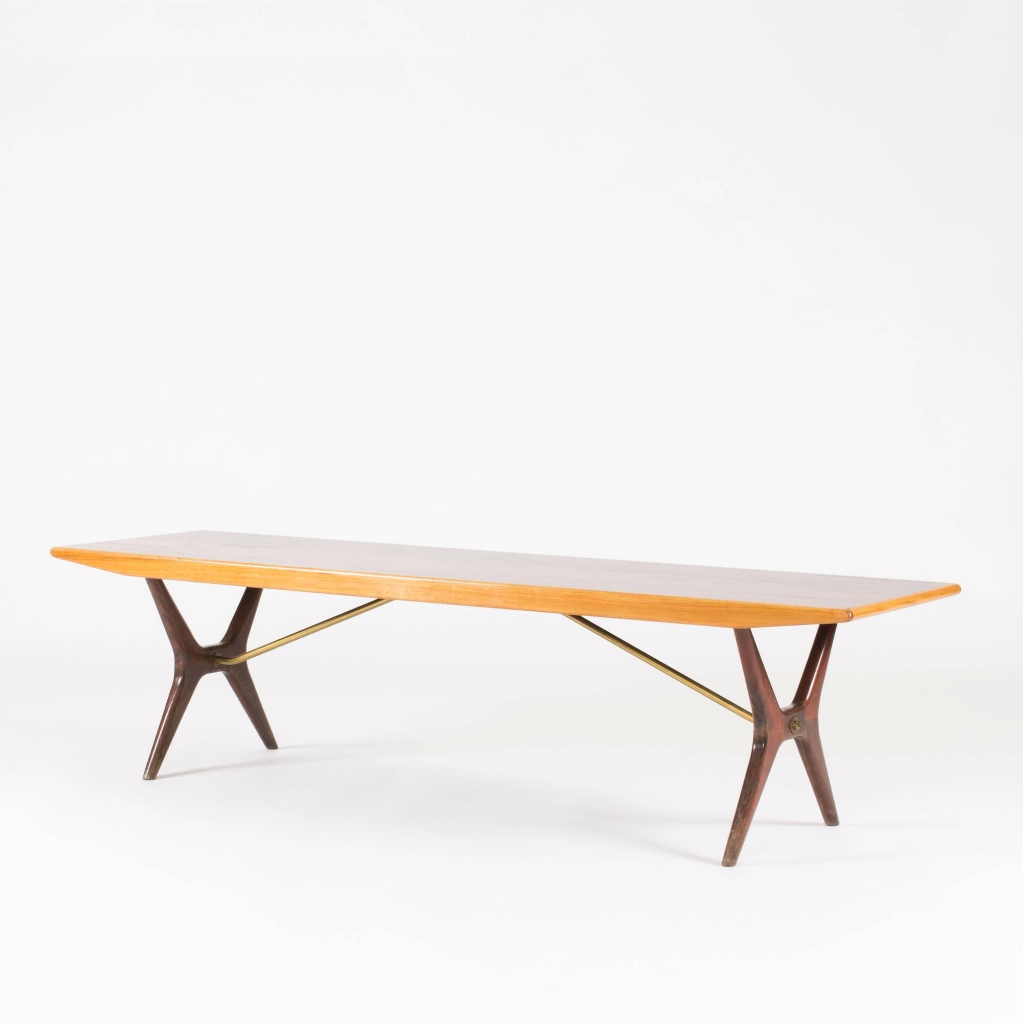 Coffee table by Karl-Erik Ekselius in a long, sleek design with contrasting kinds of wood. The base is made from rosewood and the rosewood tabletop is framed by edges of birch. Beautiful smooth veneer, saturated color. Brass extenders under the