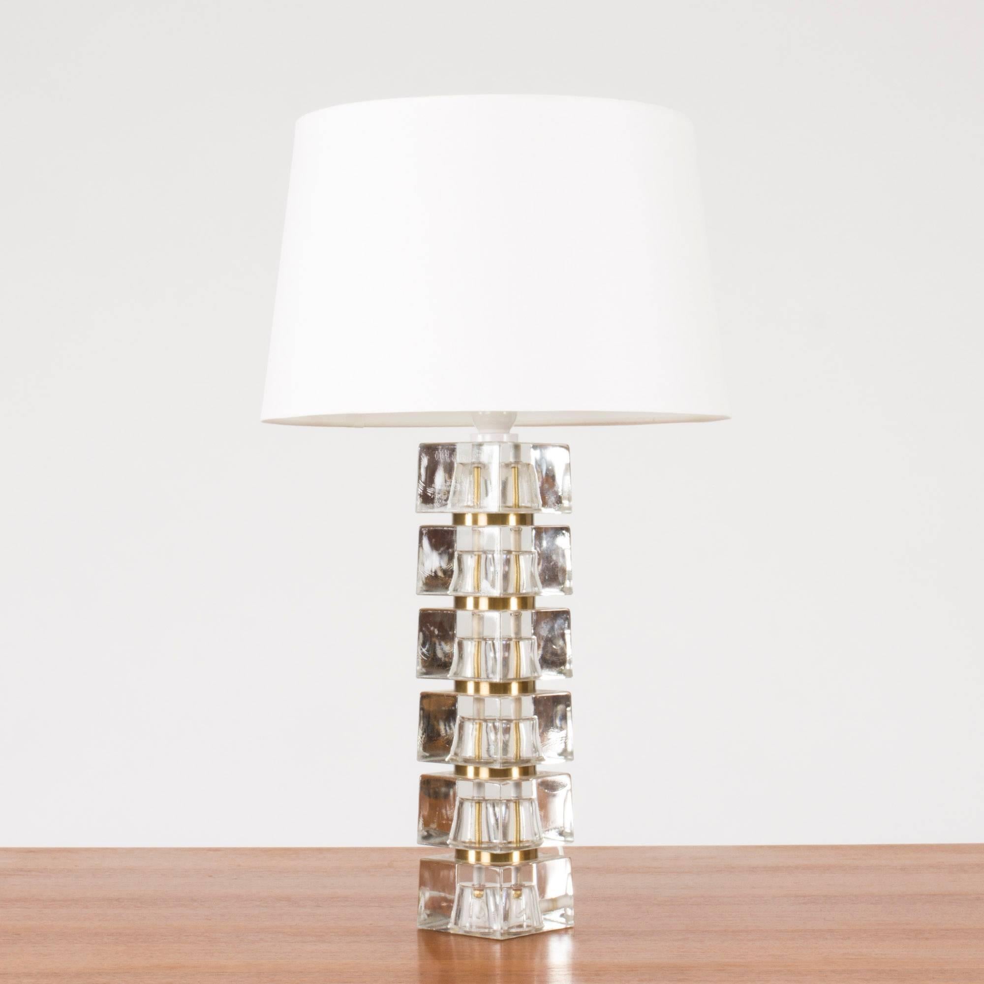 Awesome Swedish 1960s crystal table lamp with base made from translucent blocks. A slender brass pipe concealing the wiring runs through the middle of the base, creating a cool visual effect. The sections between the blocks are painted gold.