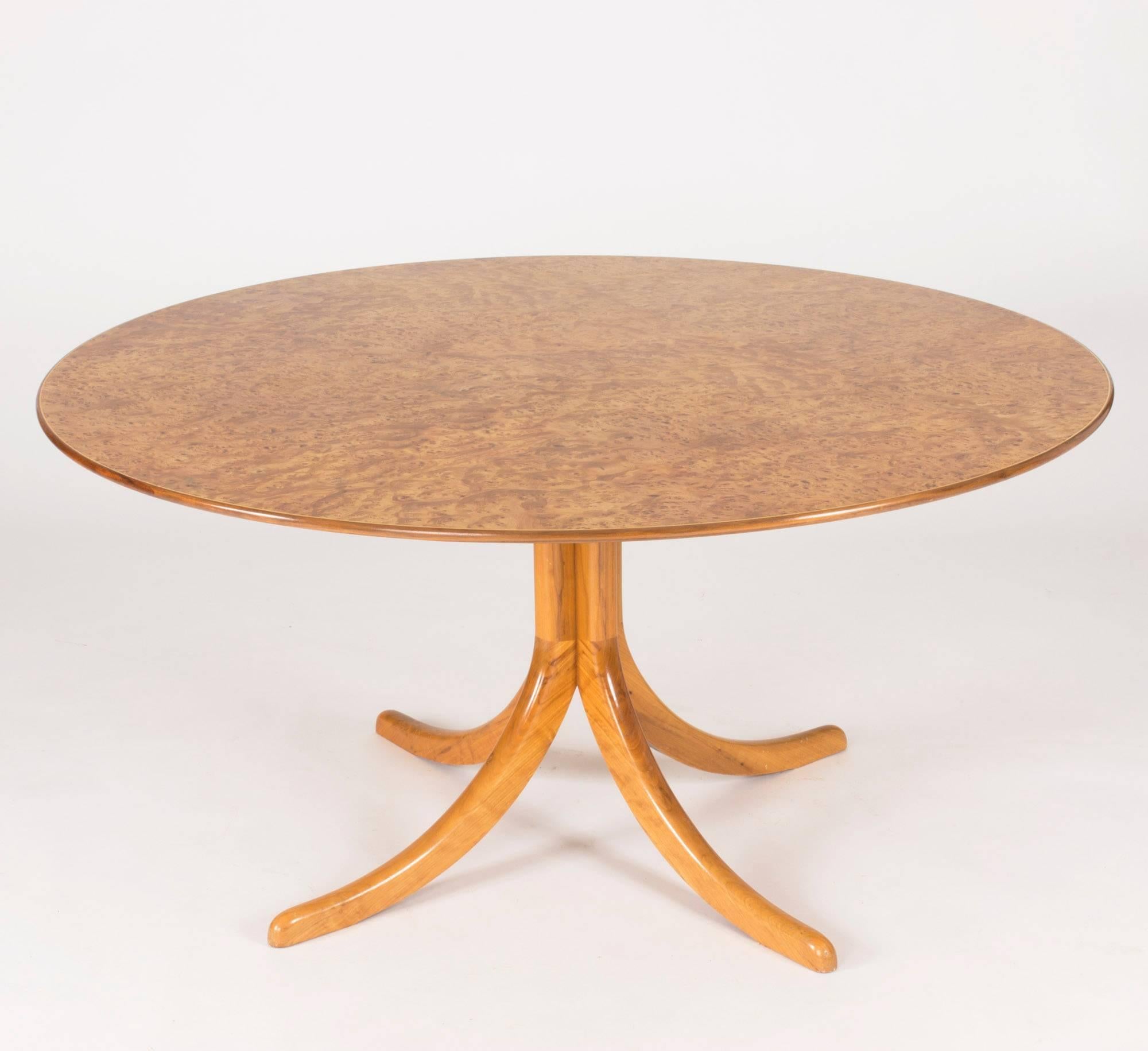 Stunning dining table by Josef Frank with a mesmerizing alder root tabletop in beautiful condition. The pattern seems to move and whirl like water in a stream, giving it life and endless variation. Pedestal base with four feet.
