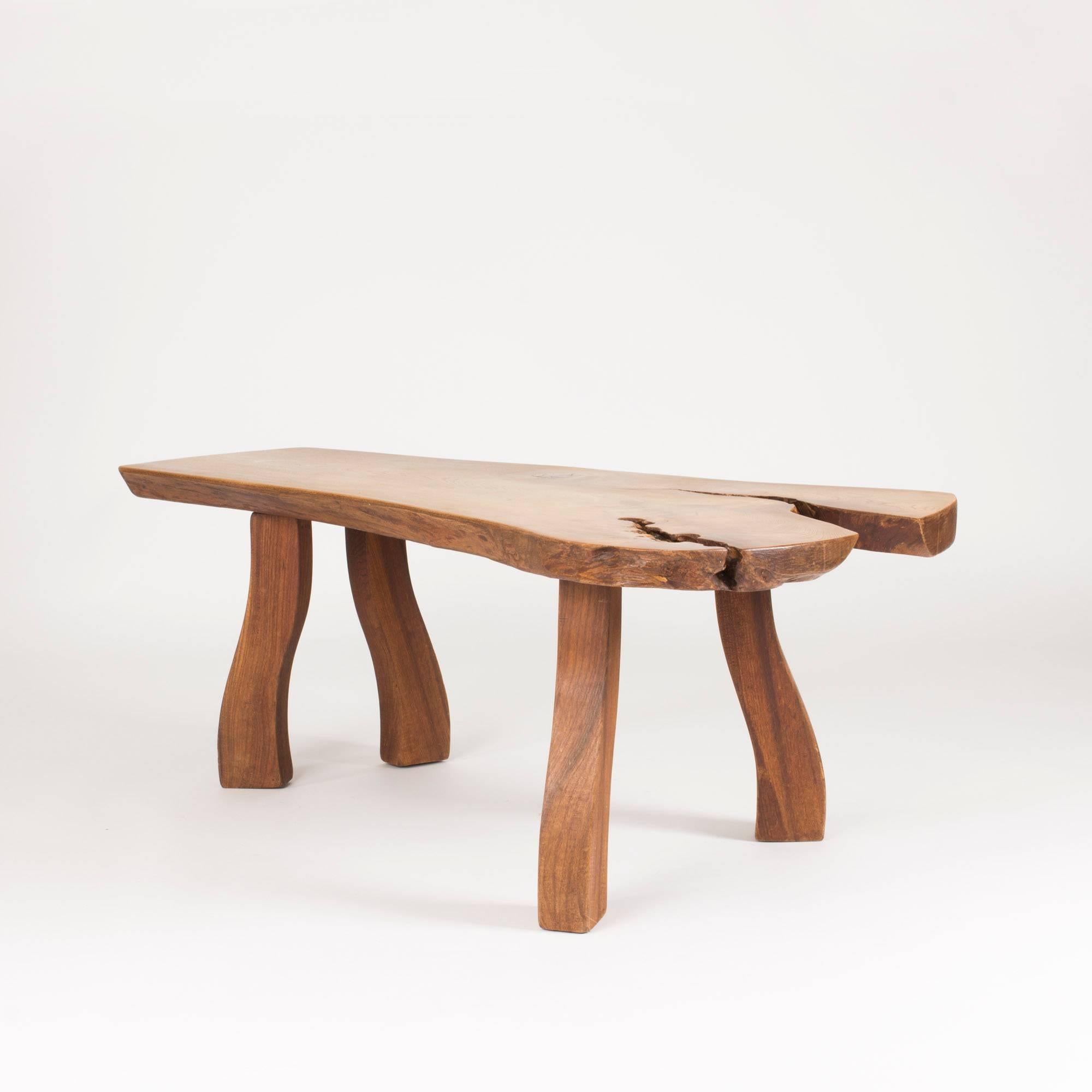Striking elmwood coffee table by Carl-Axel Beijbom, made from an elmwood slab with interesting knots and wood grain. Beautiful, oiled surface. Sturdy, sculpted legs that pick up the organic design of the tabletop. Can alternatively be used as a side