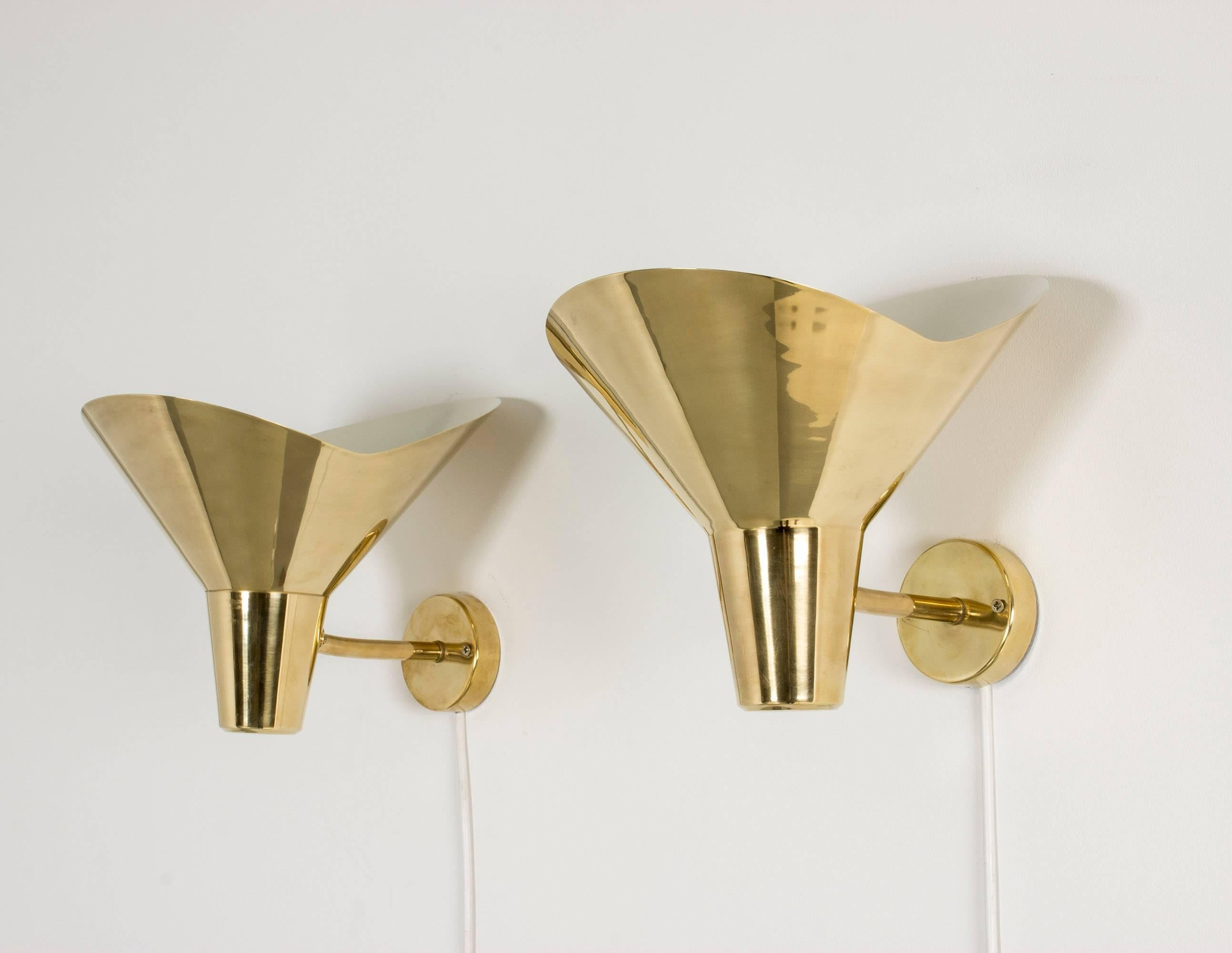 Pair of beautiful up light wall sconces by Hans Bergström, made in brass with white lacquered insides. Lovely undulating edges.