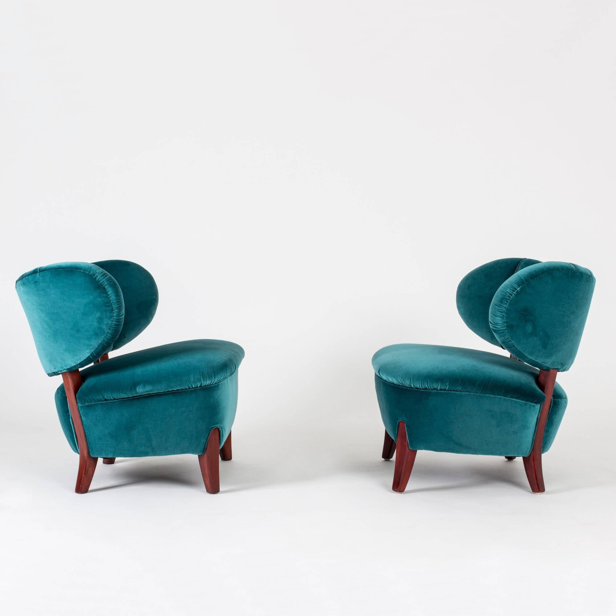 Pair of beautiful lounge chairs by Otto Schulz, upholstered with petrol blue velvet and decorated with braided ropes in the same color on the backrest. Wooden legs stained rich reddish brown.