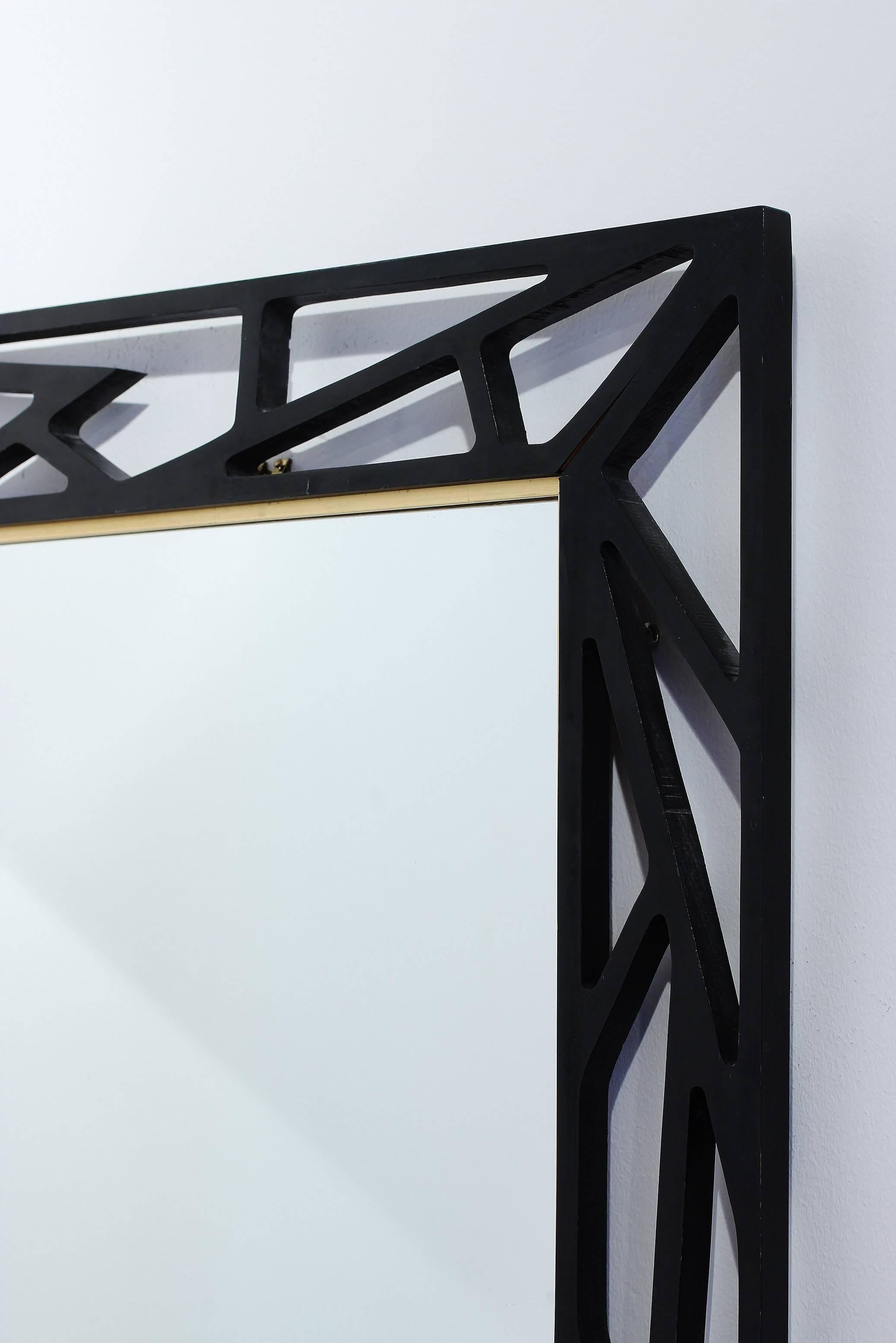 Rare mirror, model no. 135, produced by Eden Spegel. Handmade geometrical wooden frame. Black lacquer with golden frame edging. Great original condition with very few signs of wear.