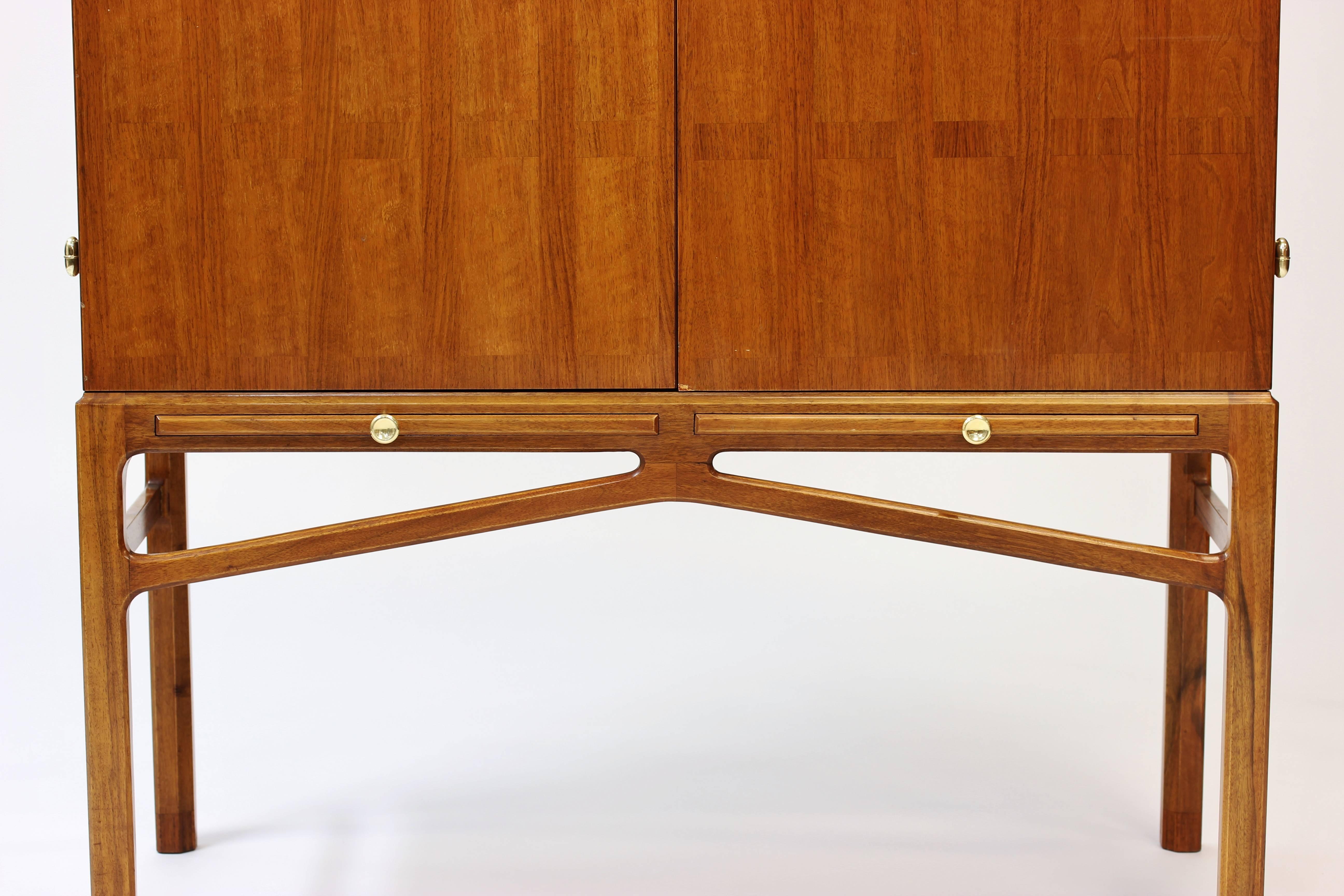 Cabinet by Carl-Axel Acking. Made by NK furniture and sold trough Ferdinand Lundqvist in Gothenburg. In mahogany with brass details. Exceptional craftsmanship and design.