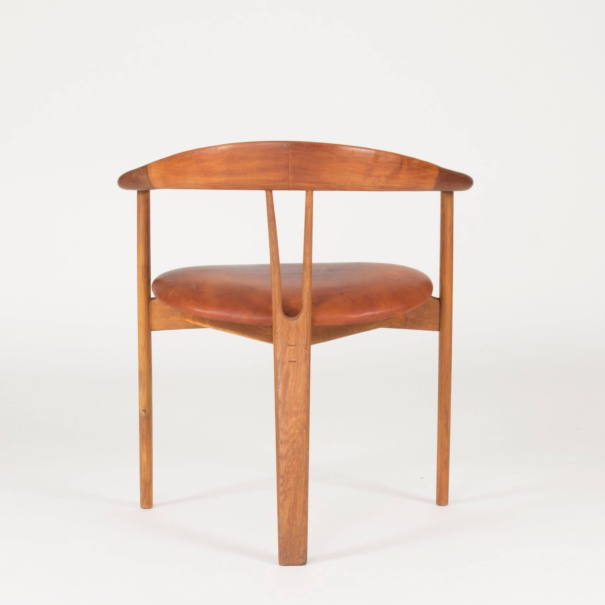 Beautifully sculpted teak armchair by Arne Hovmand Olsen. Original leather seat with great patina, lovely details on the armrests and on the backrest that hide joinery.