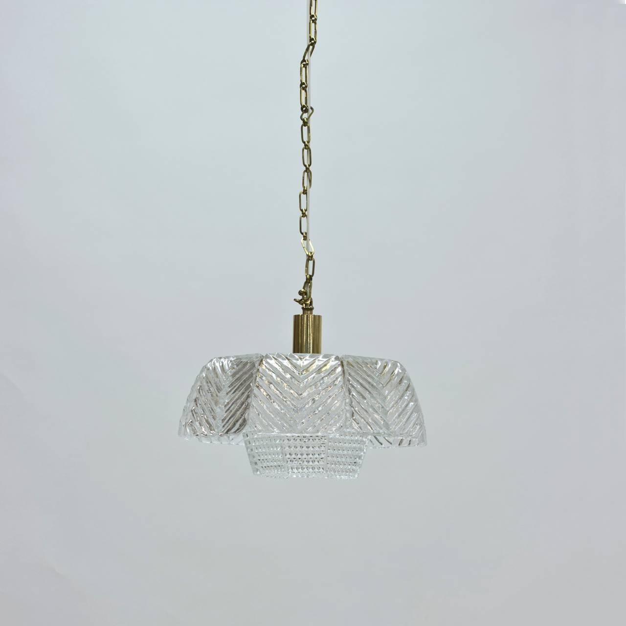 Elegant glass pendant lamp by Carl Fagerlund with organic glass in an angular 1960s design with the folded glass pieces hanging loose on the frame. The brass frame and chain create a modern contrast. New wiring.
Measures: Height 110 cm (including