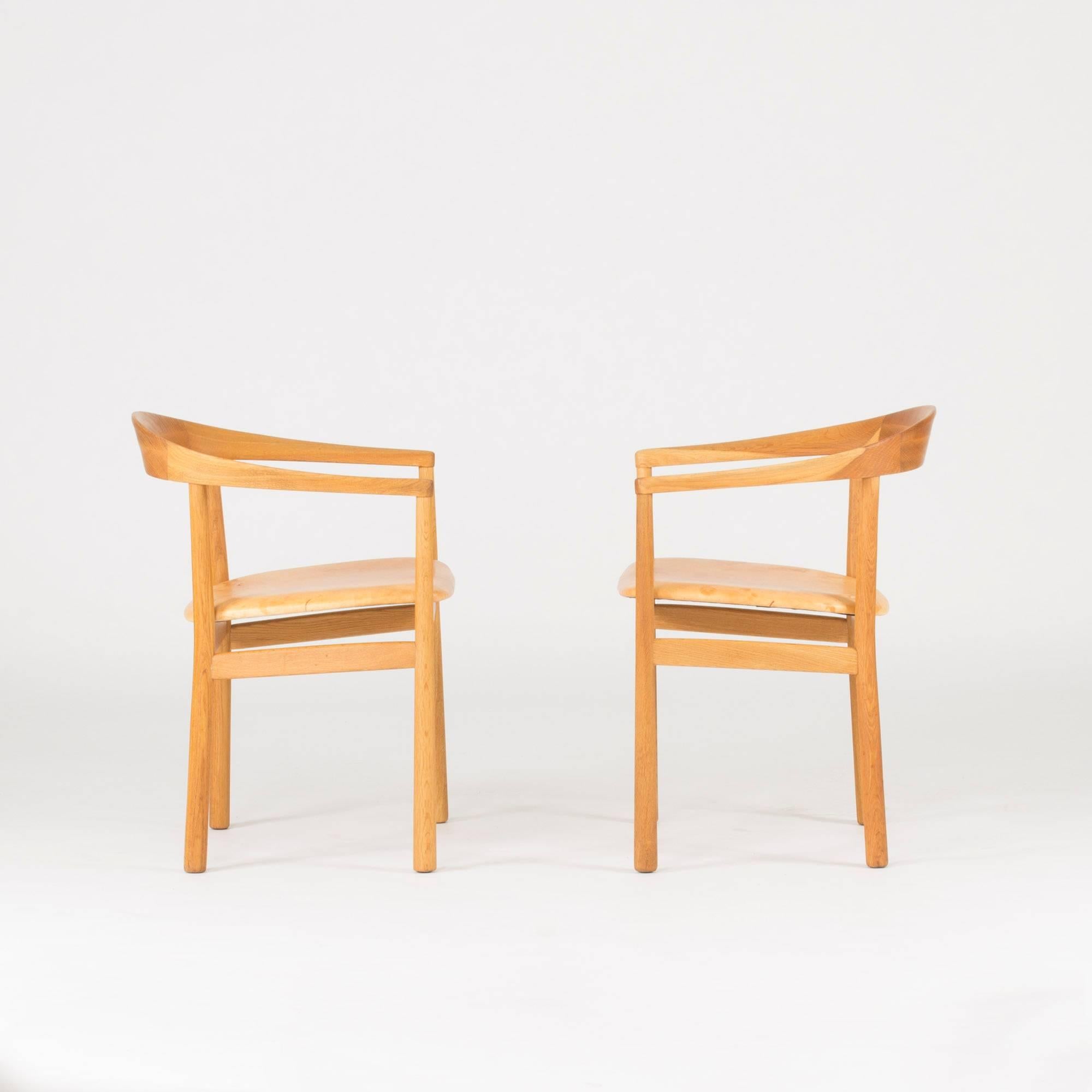 Pair of beautiful “Tokyo” armchairs by Carl-Axel Acking, made from oak and upholstered with patinated blonde leather. The “Tokyo” model was created in 1959 for the Swedish embassy in Tokyo.