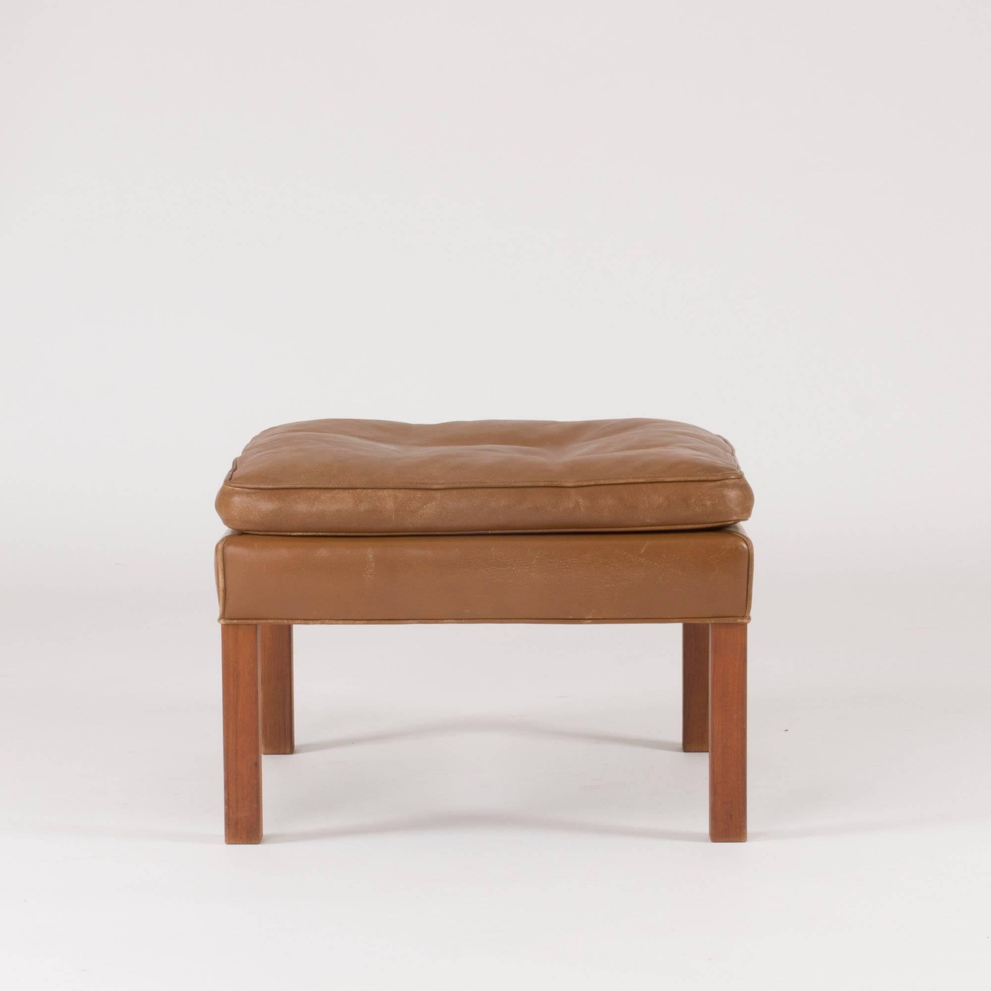 Elegant, timeless and comfortable leather ottoman by Børge Mogensen that can be combined with his sofas and armchairs or enjoyed by itself. Brown leather and oak legs.