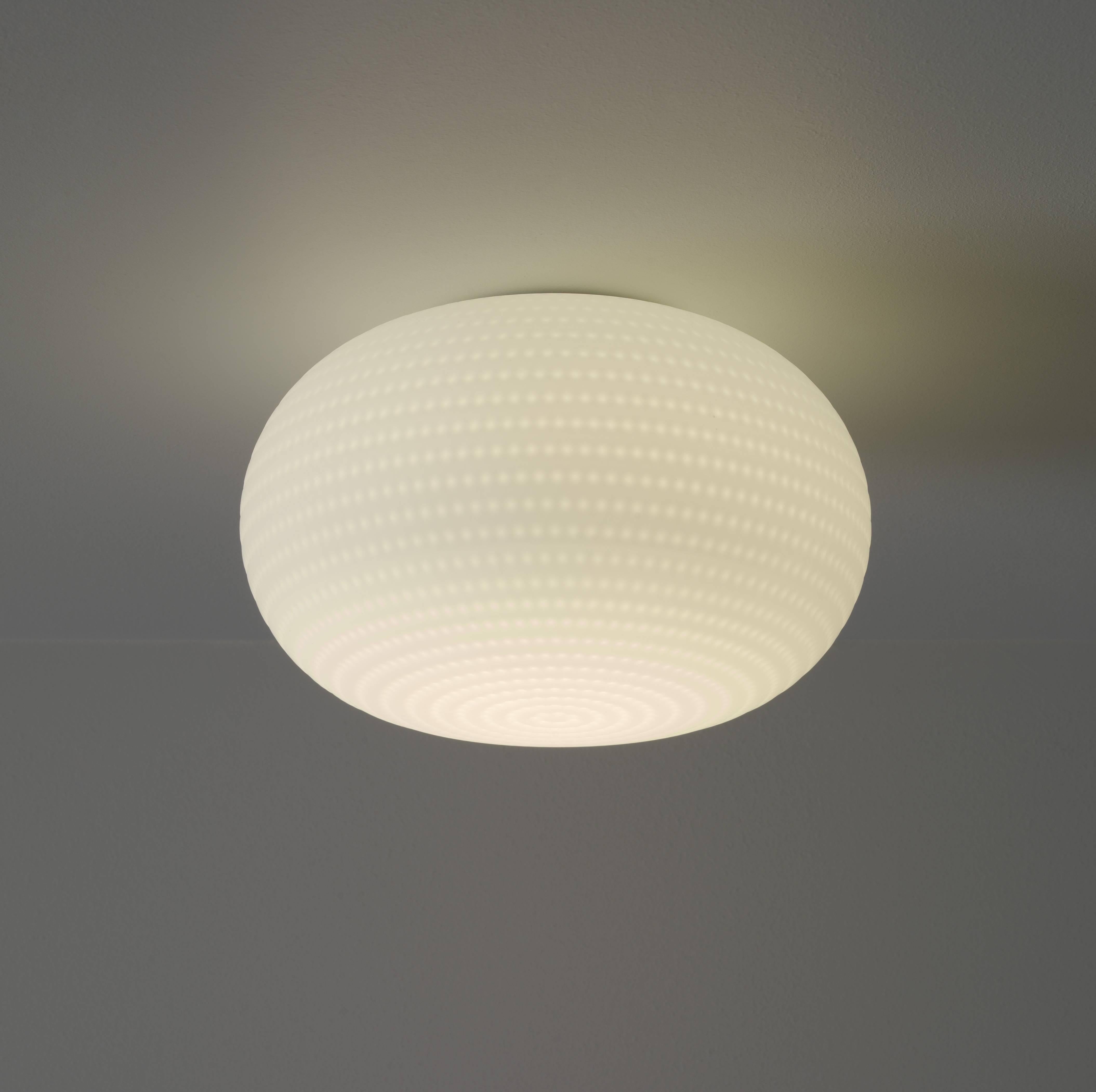 Its beautifully balanced shape is enriched and made unique by an orderly series of delicate, light grooves that, on the white volume of the glass, look like tiny prints on fresh snow.

Dimensions: (ø 50 × 35 cm).
Bulbs: 1×150W E26.
 