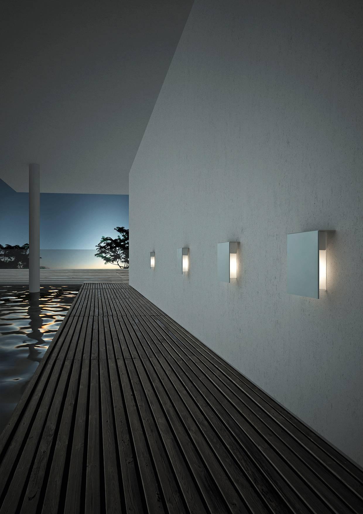 Designed by David Chipperfield in 2008 and manufactured by Fontana Arte, the Corrubedo outdoor wall lamp is structured in stainless steel with the diffuser in opaline white polycarbonate with a transparent borosilicate glass shield. The lamp comes