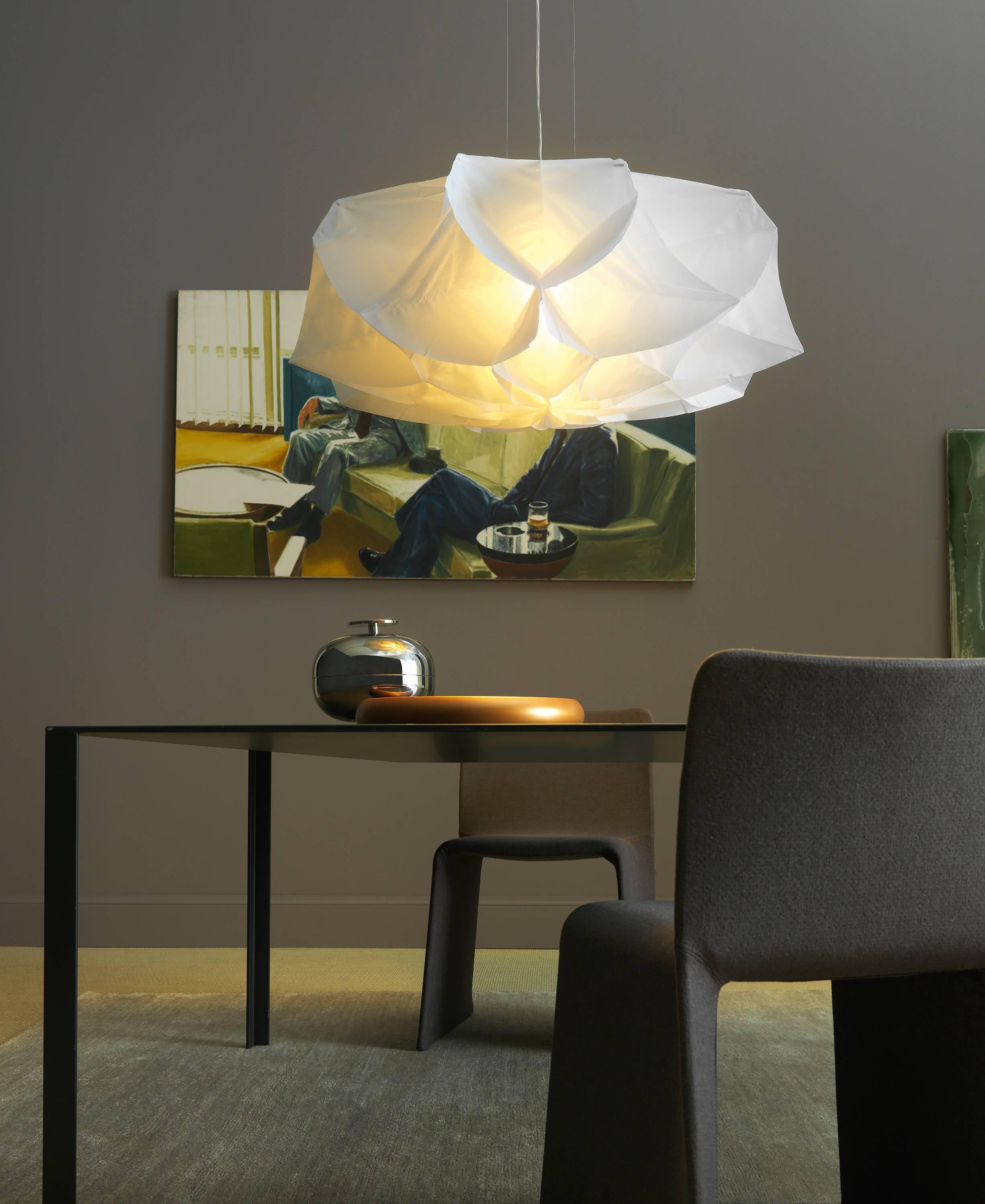 Designed by Studio Drift in 2013 for Fontana Arte, the Albedo suspension lamp makes a big impact in a poetical rendering of a beautiful flower shape. Lightweight and immaterial, Albedo is elegant and refined. The fabric diffuser is laser cut and