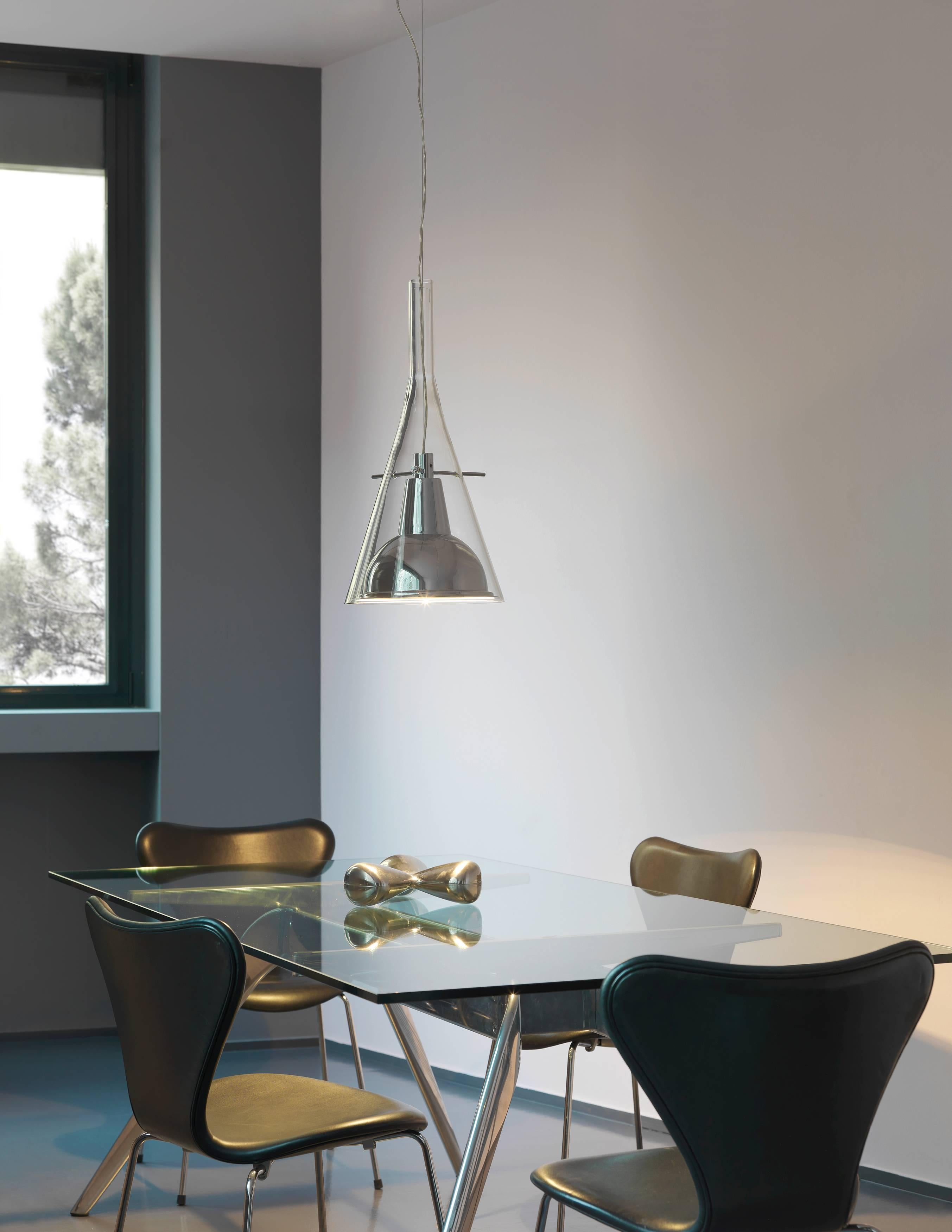 From designer Franco Raggi manufactured by Fontana Arte, the flute suspension lamp was designed in 1999 and is a glass cone that holds the chromed aluminium reflector, supported by three slender metal rods. Equilibrium and lightness for this family
