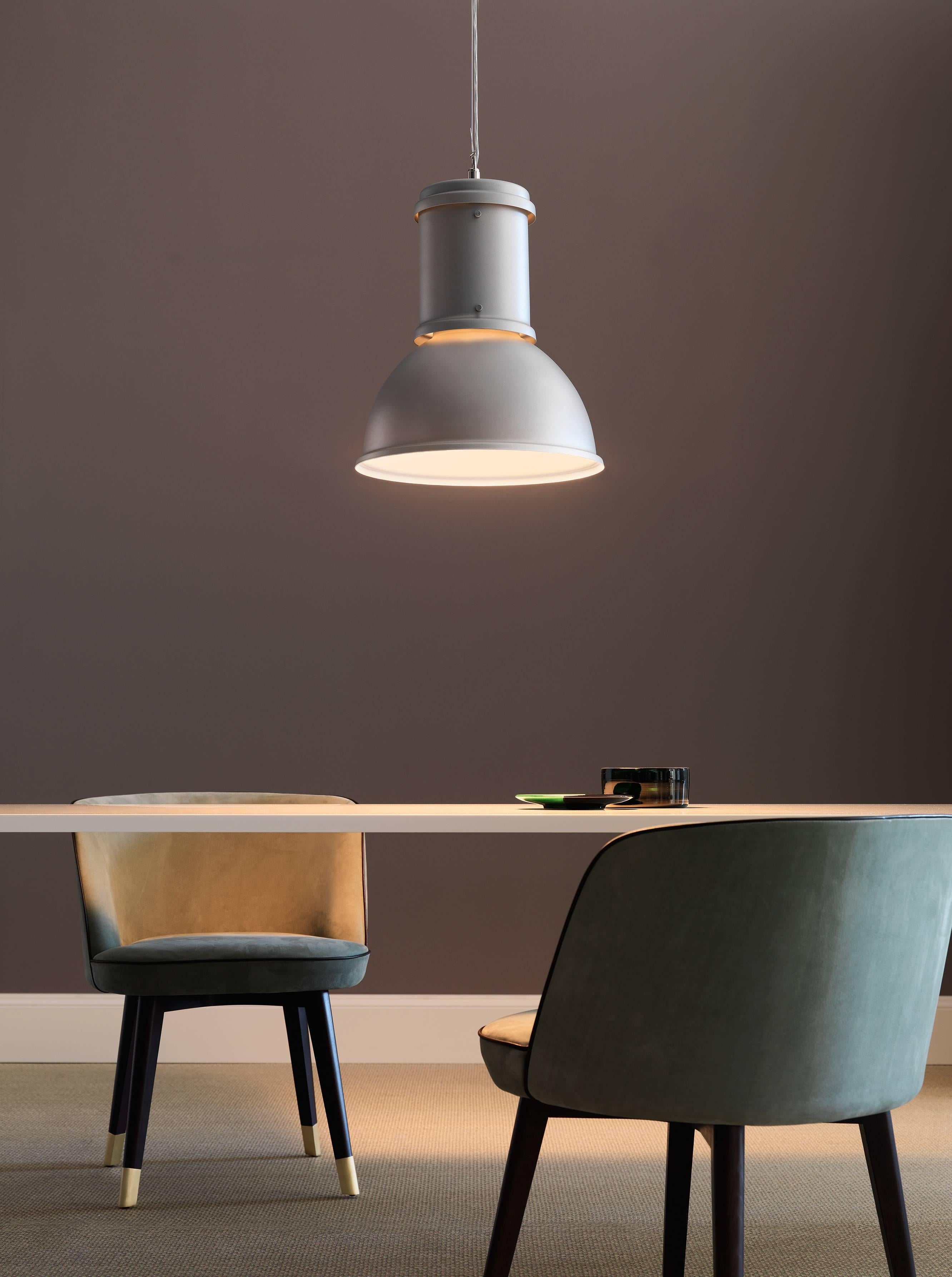 From the archives of Fontana Arte, the Lampara Suspension Lamp in natural
aluminium with white painted interior was designed in 1965. It is reminiscent of Industrial architecture, and has a natural or chromed aluminium shade and the reflector is