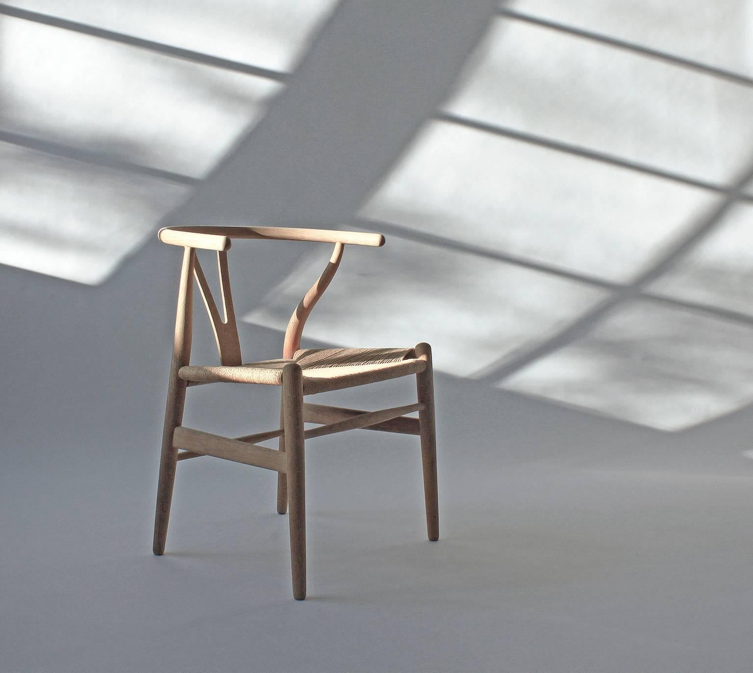 An oak Wishbone chair, called the Y-stole in Denmark due to the Y-shaped structure at the back. Designed by Hans J Wegner for Carl Hansen & Søn (model CH 24). Seat with woven papercord.