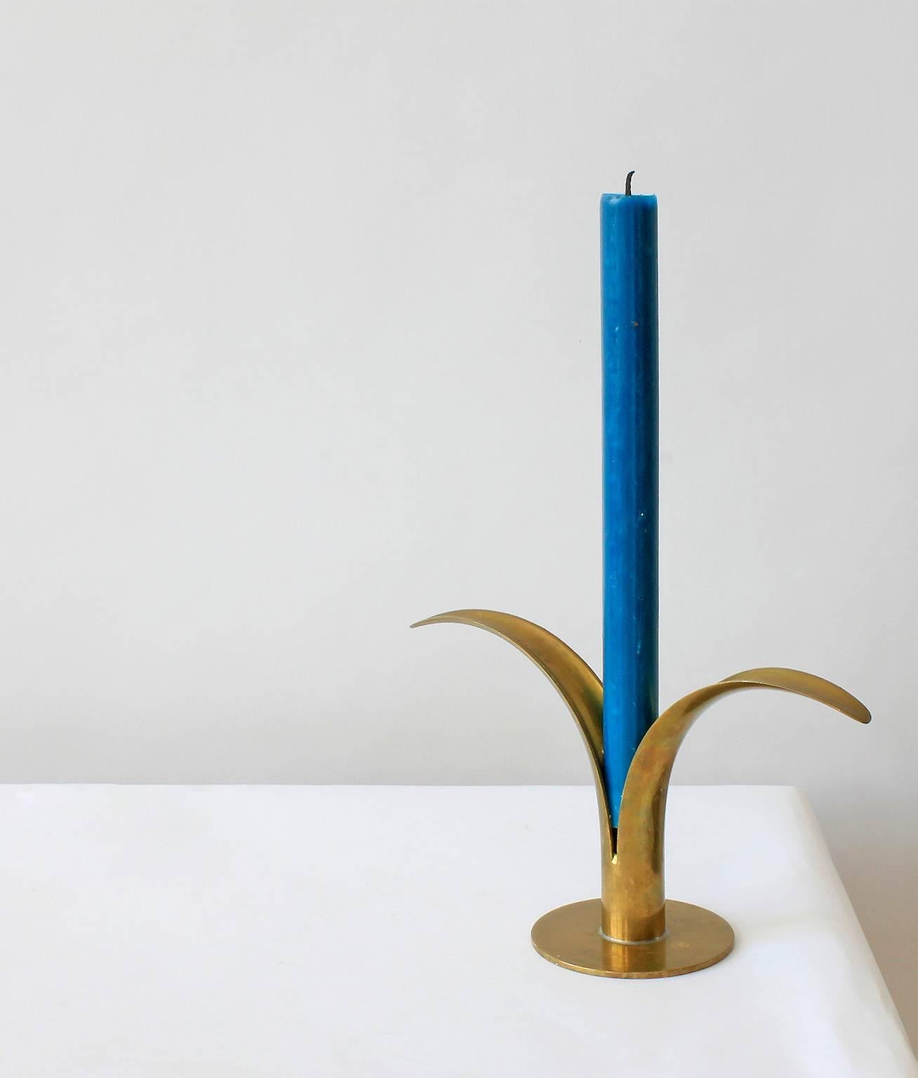 A pair of brass Liljan candle holders design by Ivar Ålenius Bjork for the Swedish maker, Ystad Metall, in the 1930s.