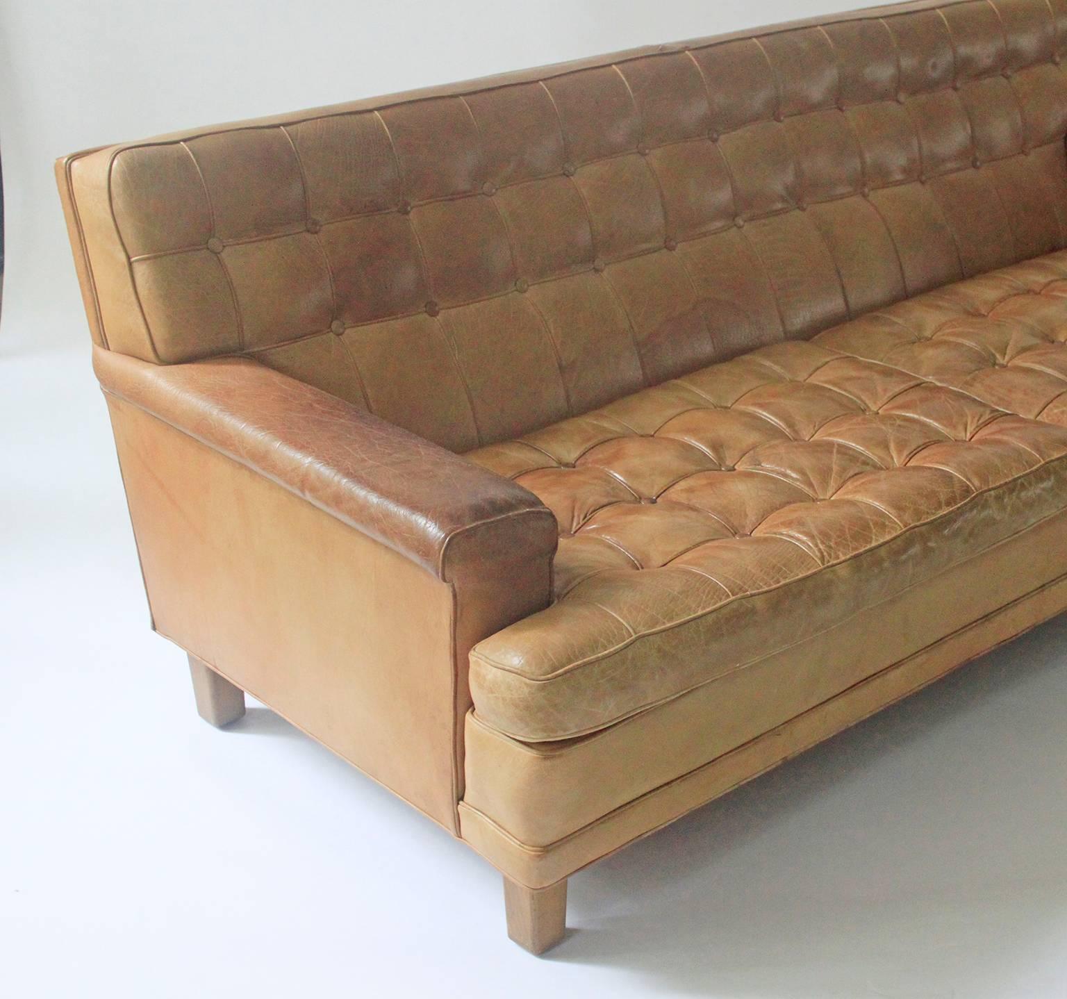 Supremely comfortable, long and deep sofa in soft patinated cognac leather by Arne Norell, Sweden. A much sought after colour in excellent condition.