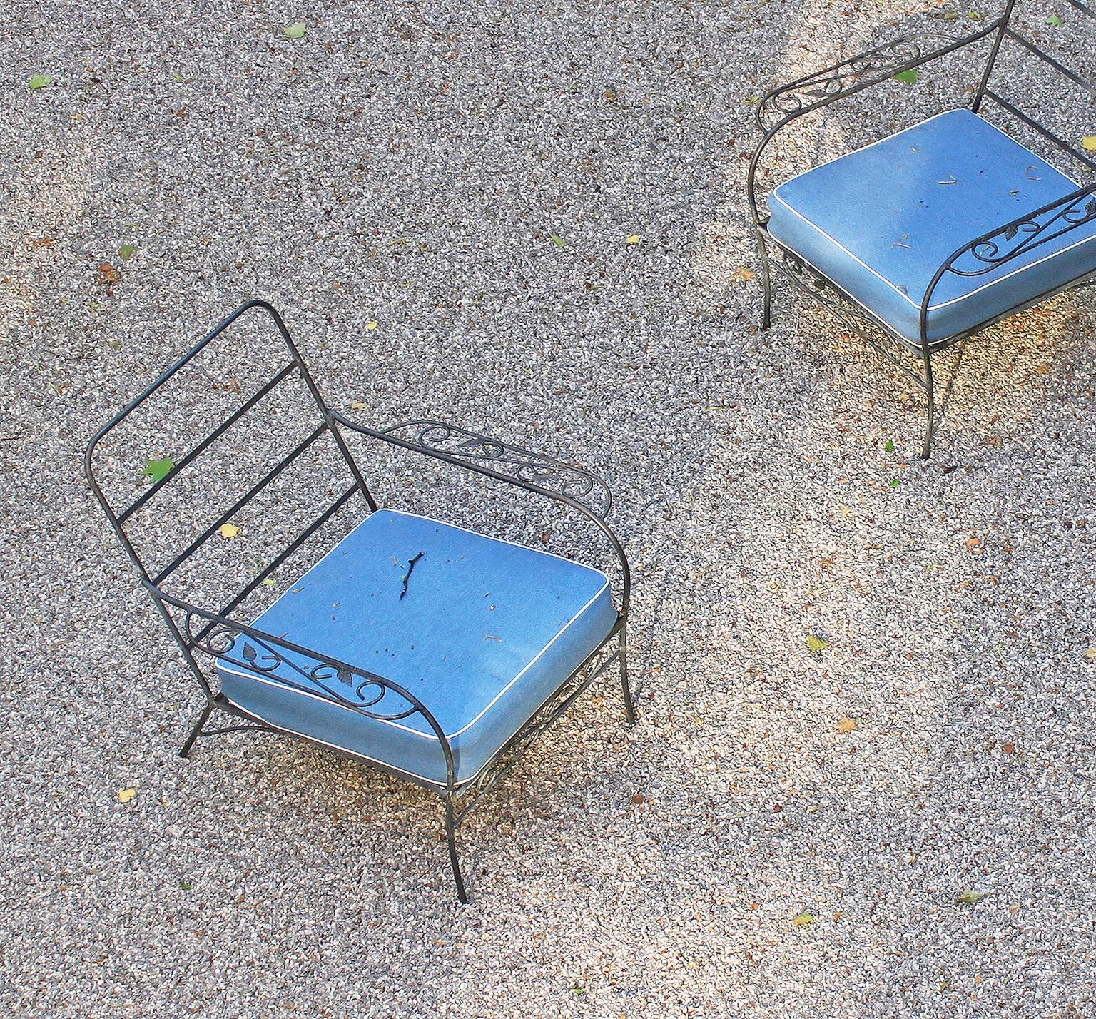 An elegant pair of iron-framed Swedish garden chairs with new rain-resistant Sunbrella seat and back cushions. The cushions retain the original internal springs.