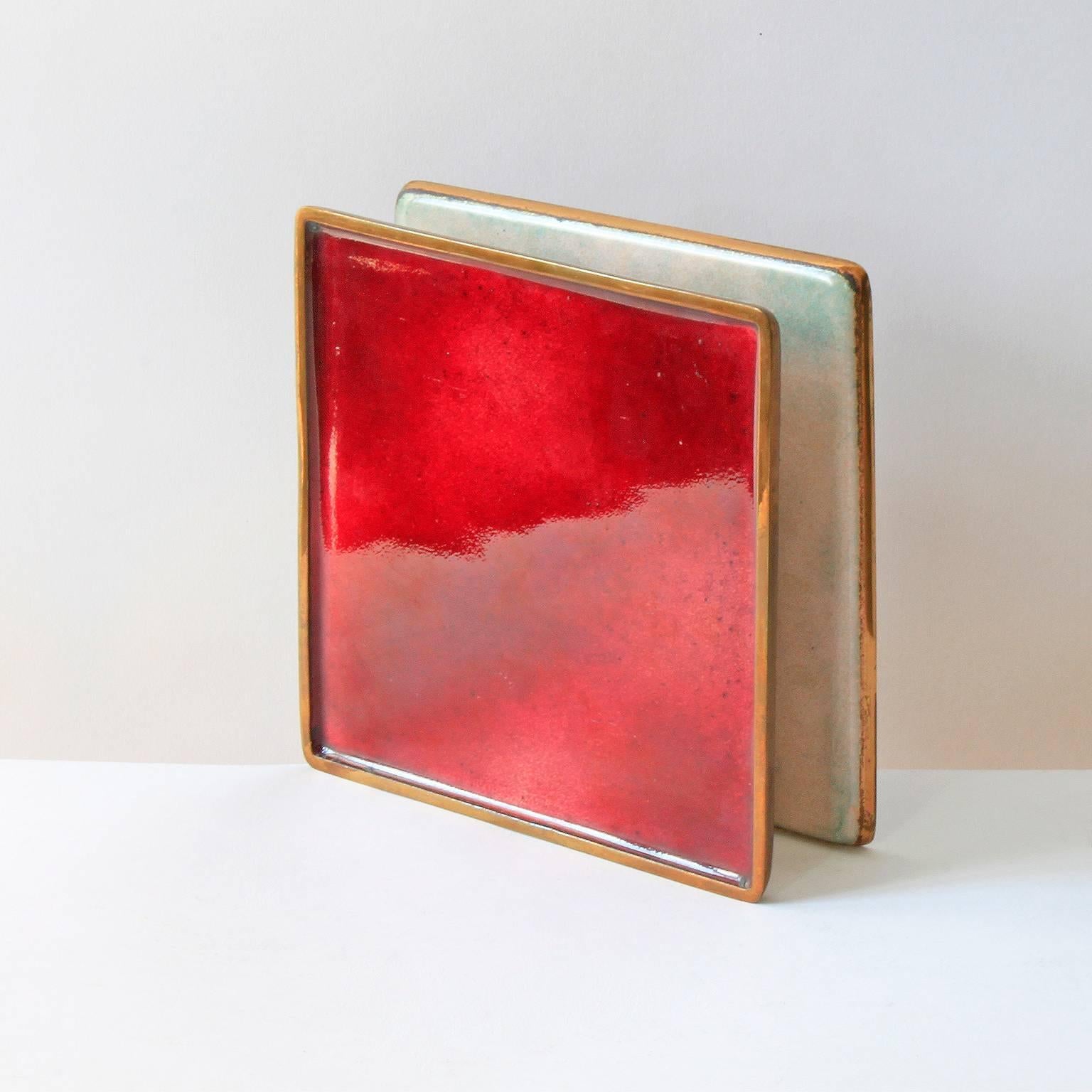 Spectacular door handles in hand-polished enamel on brass created in collaboration by two of Italy's most important 20th century designers, Gio Ponti and Paolo De Poli. This example features a deep red glaze on the exterior surfaces and a
