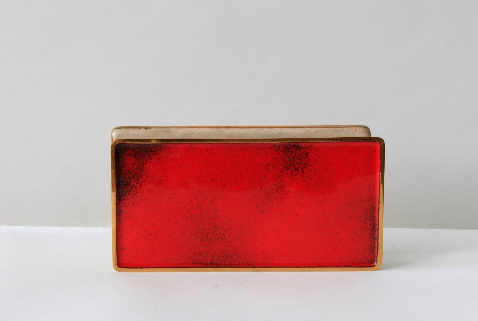 Spectacular door handles in hand-polished enamel on brass created in collaboration by two of Italy's most important 20th century designers, Gio Ponti and Paolo De Poli. This example features a strong red glaze on the exterior surfaces and a