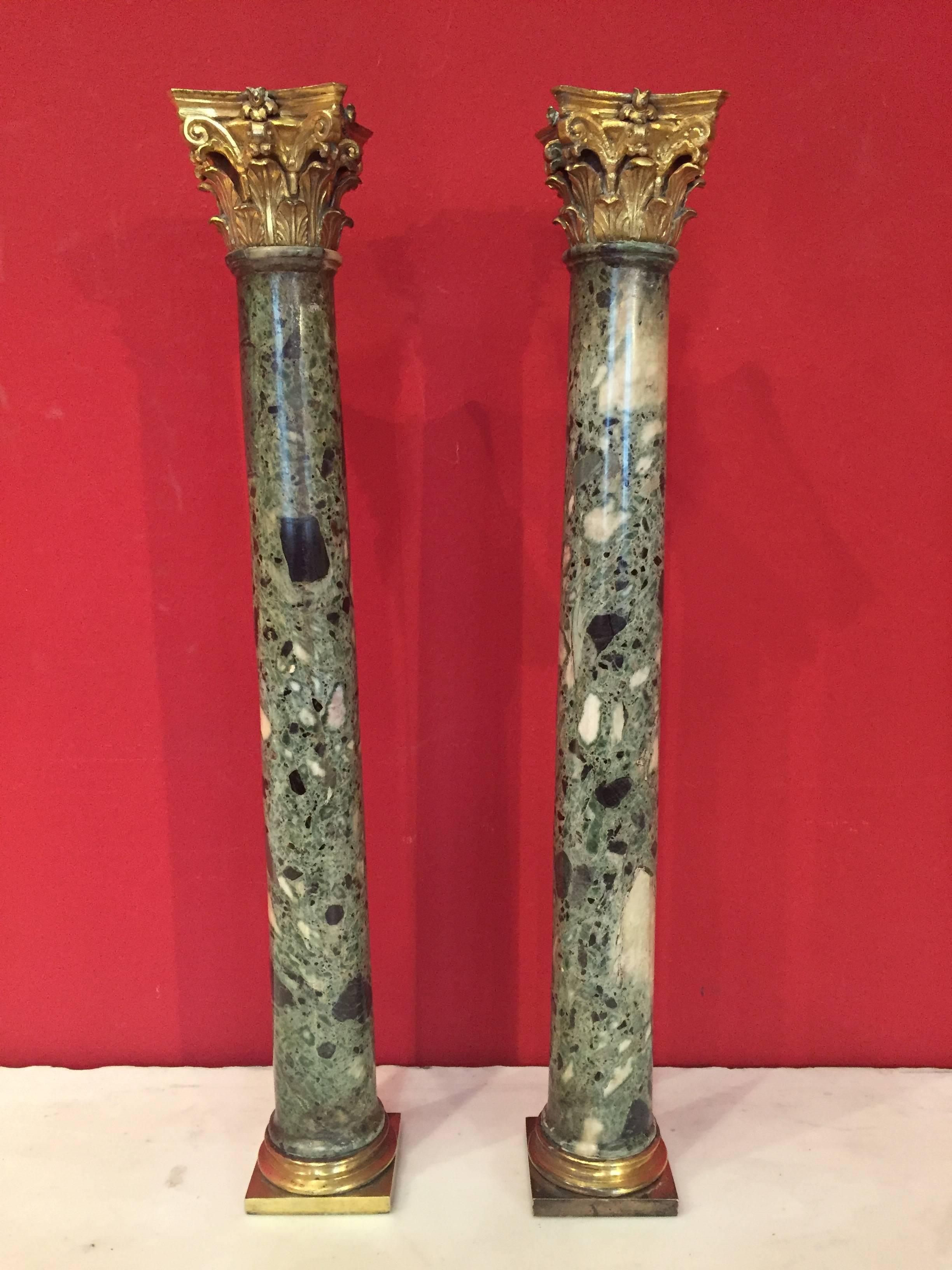 A pair of 19th century green Alps marble columns with gilt bronze bases and capitals.