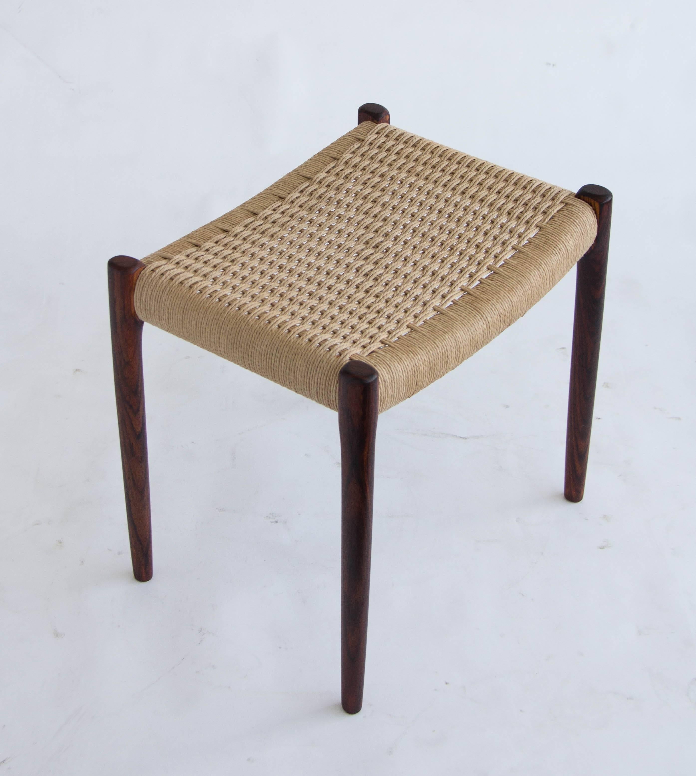 Model 80A Ottoman by Niels Møller.

Simple rosewood ottoman or footrest with Danish cord upholstery and slightly tapered legs, designed by Niels Møller for JL Møllers Møbelfabrik of Denmark. The cord, made of twisted paper is woven out of one