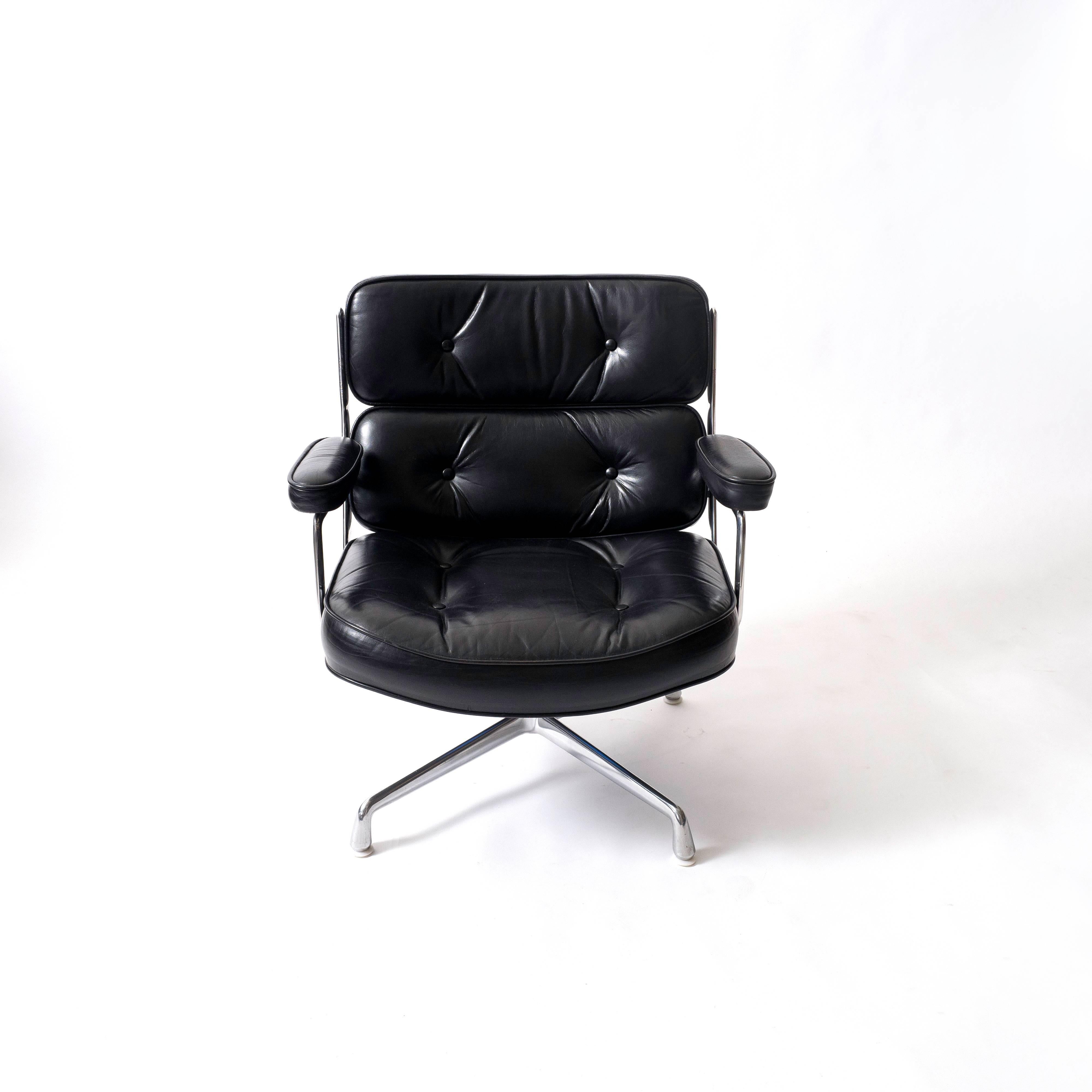 Designed in 1960 by Charles and Ray Eames for the Time Life Building in Manhattan, these chairs feature a polished aluminum frame and sumptuous tufted cushions in the original black leather. The chair sits on four plastic glides. This is the
