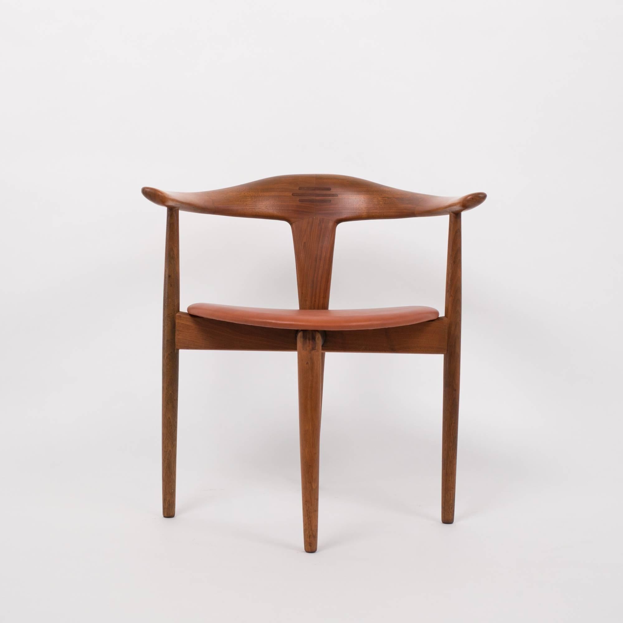 A single accent chair with a distinctive leg pattern by Pelle Pedersen and Erik Andersen. Made by the Danish Randers Møbelfabrik and imported to the US by M M Moreddi in 1963, the chair's four legs are arranged in a diamond pattern, with two legs