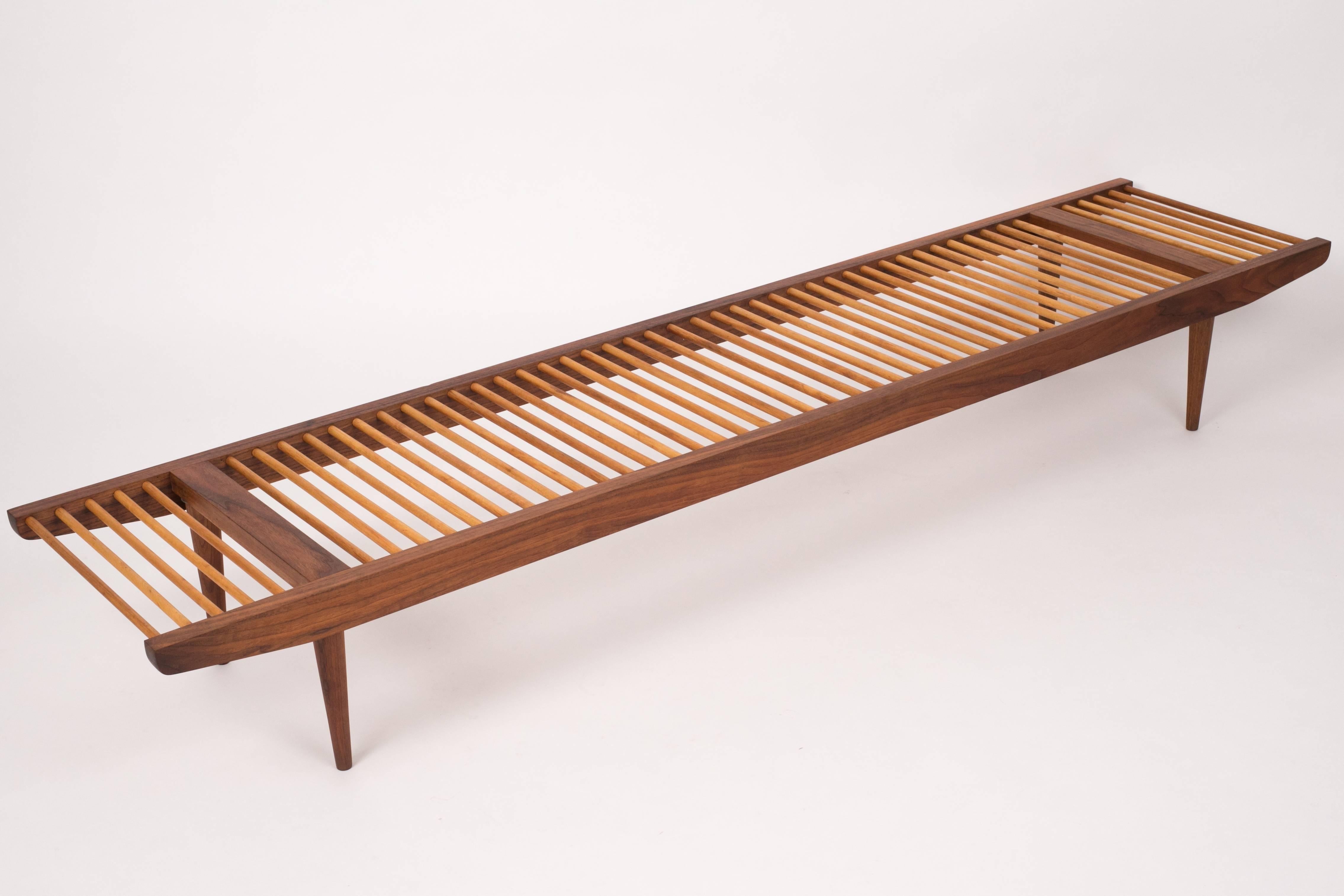 A multifunctional piece designed in the 1950s by Milo Baughman for Glenn of California. Most commonly used as a bench, the piece has a walnut frame that tapers towards each end with walnut spacers and delicate rounded legs. The seat is created from