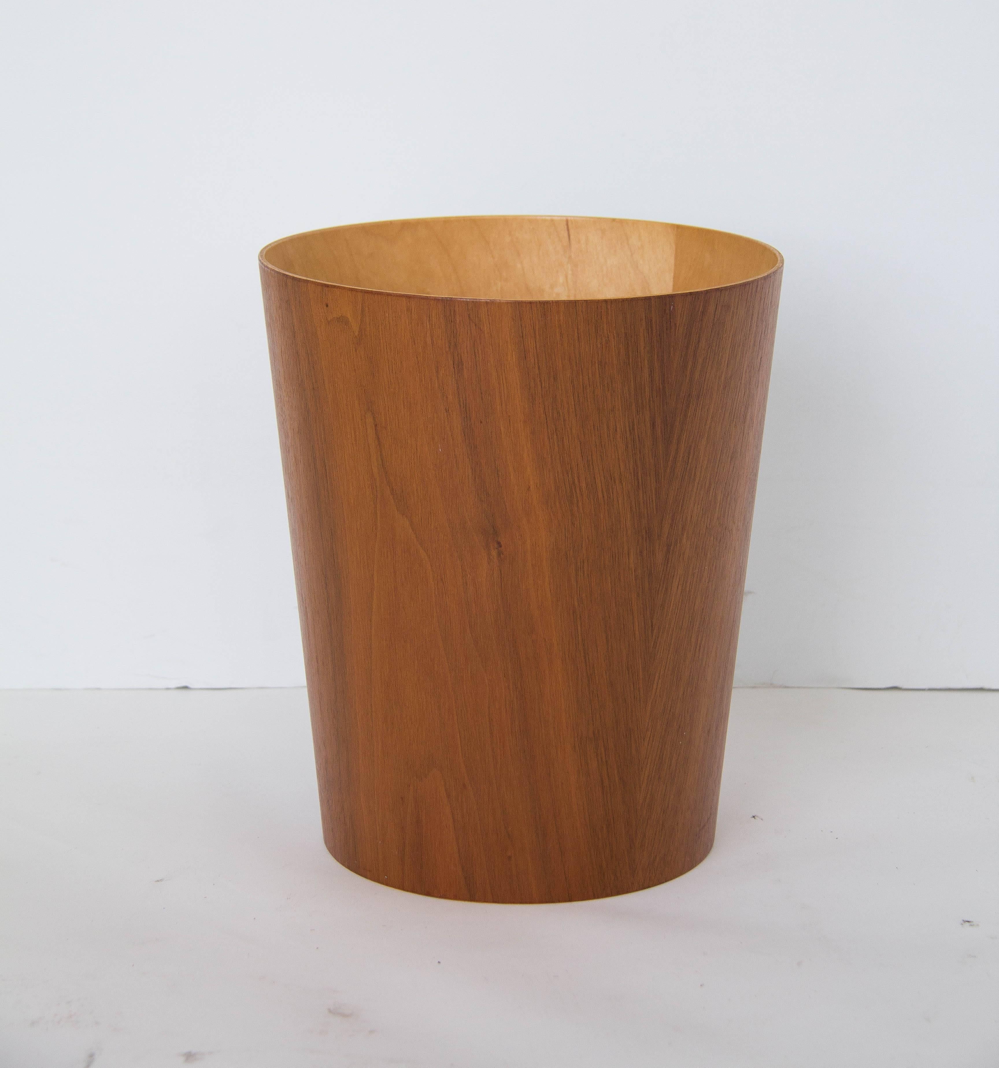 Swedish design house rainbow wood products specialized in streamlined home and office accessories in teak veneer. This teak waste-paper basket has a delicately flared conical shape and contrasting interior in birch veneer. Stamped “Servex/Rainbow
