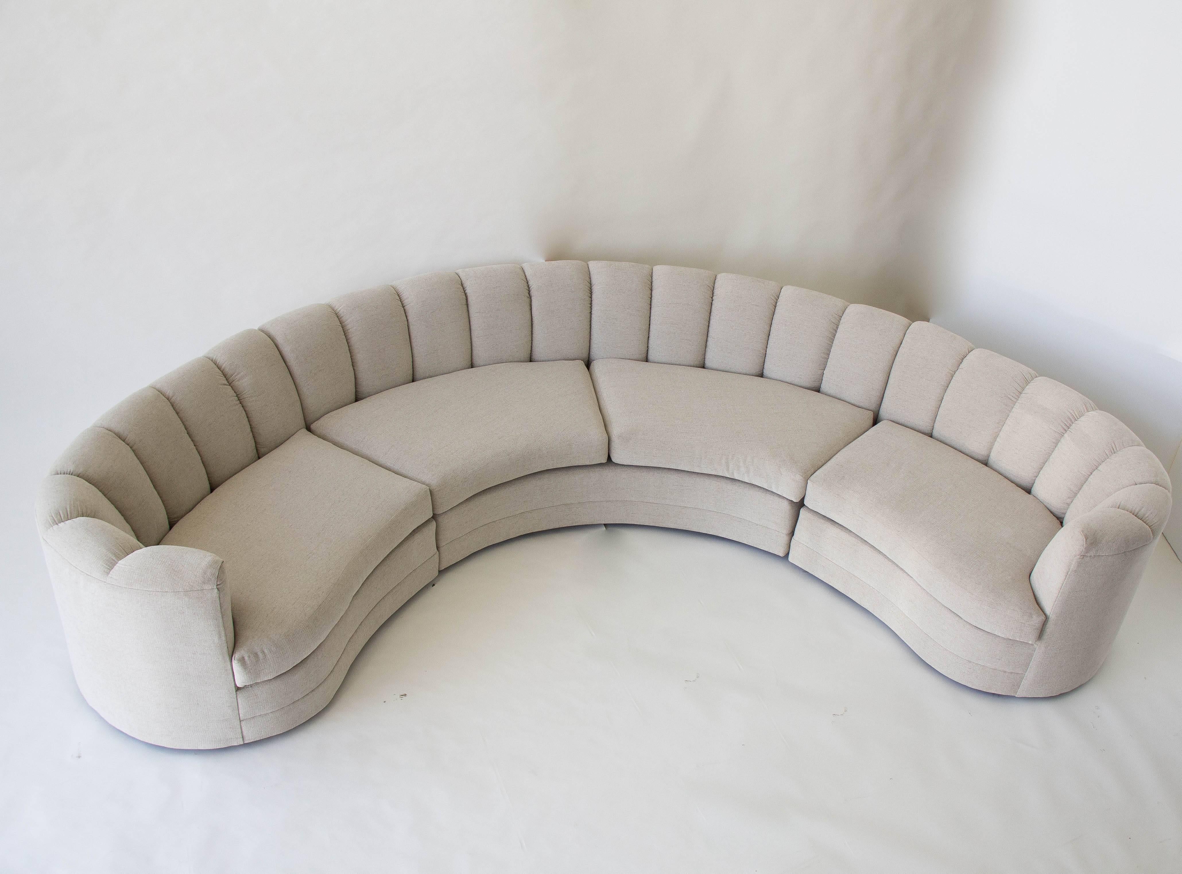 Custom-designed semicircular sofa from the late 1980s. This sectional sofa is composed of three pieces, one curved central unit and two ends, all of which have a scalloped shell back and ‘float’ on recessed wooden feet. Designed and manufactured in