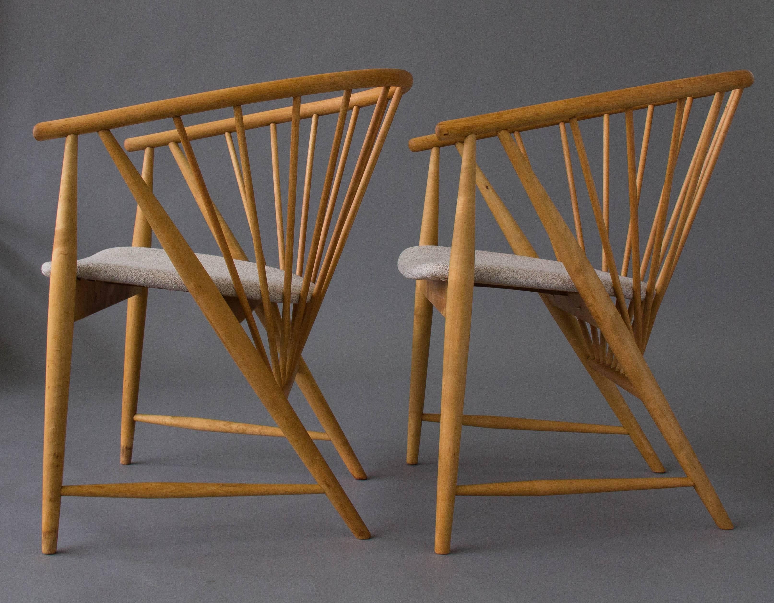 A pair of Swedish-made armchairs designed by Sonna Rosen and produced by Nässjö Stolfabrik features a sunburst of birch dowels for support and a slender, curved backrest. Designed in 1948 and awarded a MoMA good design award in 1950, this pair has