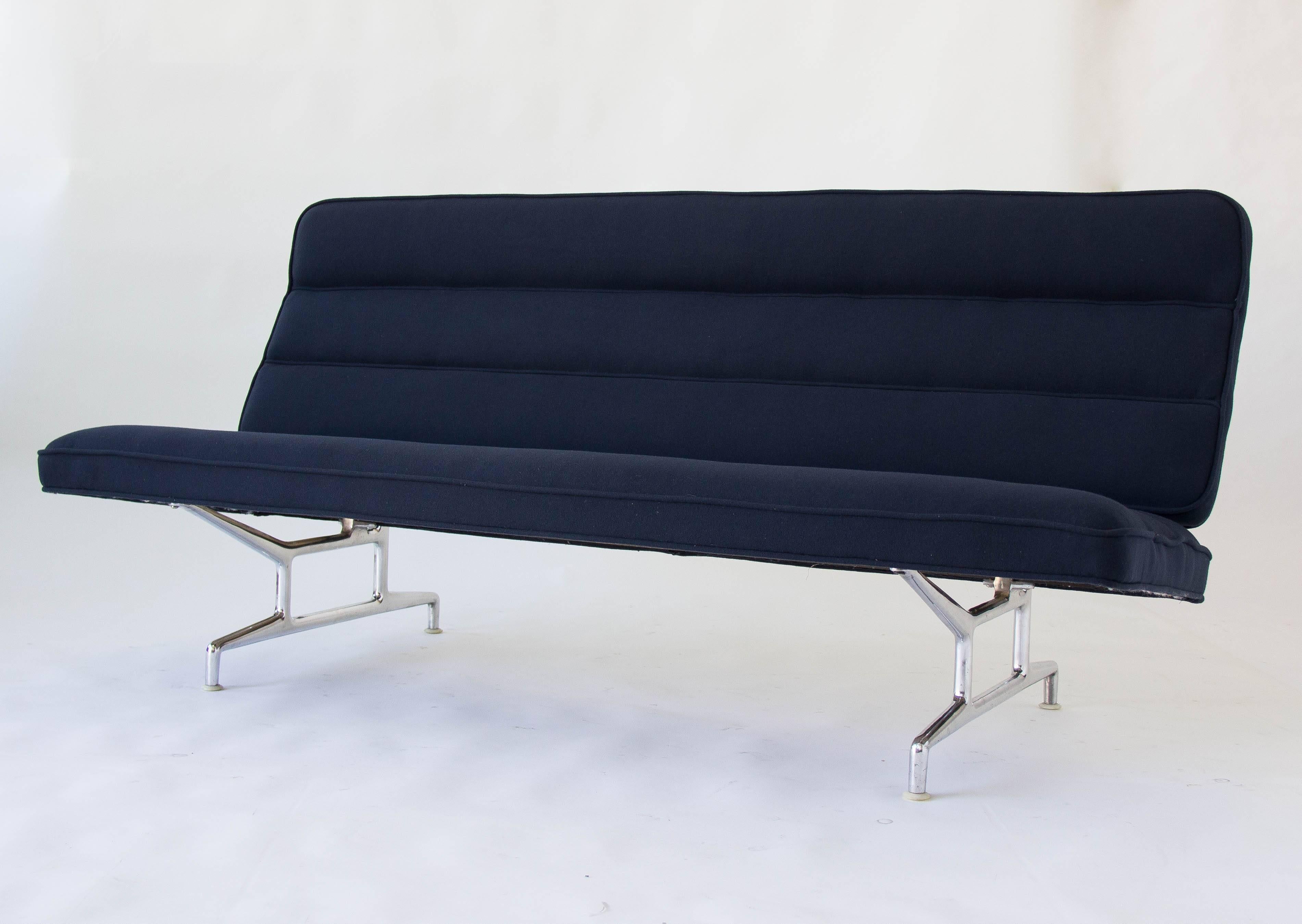 A fully restored 3473 sofa by Charles and Ray Eames for Herman Miller. Upholstered in sumptuous blue Maharam merino or cashmere textile, this minimal sofa has a gently-angled, segmented backrest and seat. The angled seat is supported by two brackets