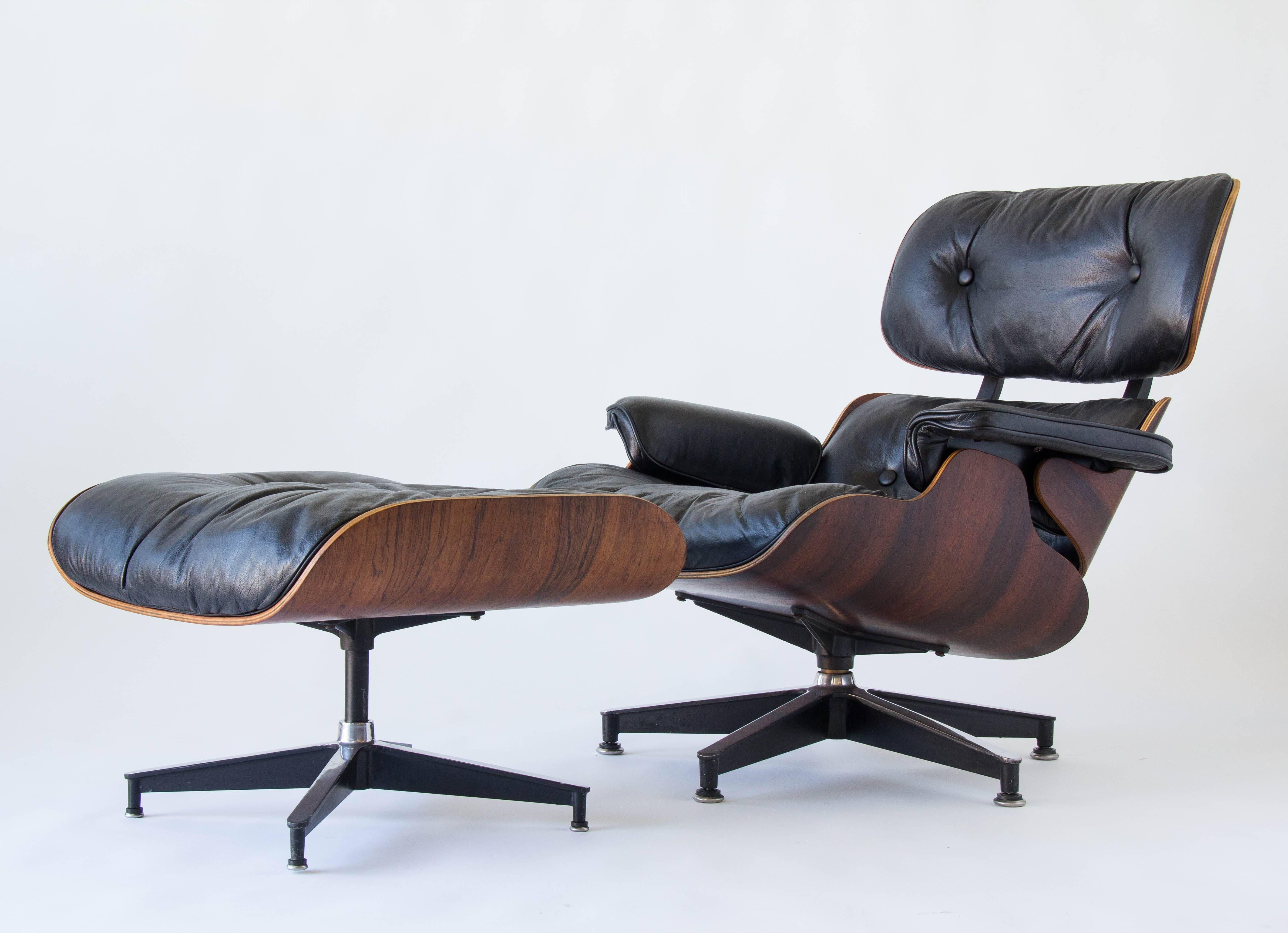 A 1960s edition of the iconic 670/671 lounge chair by Ray and Charles Eames for Herman Miller. This version has down filled cushions and round steel upholstery clips. The set is in vintage condition with the original black leather upholstery and