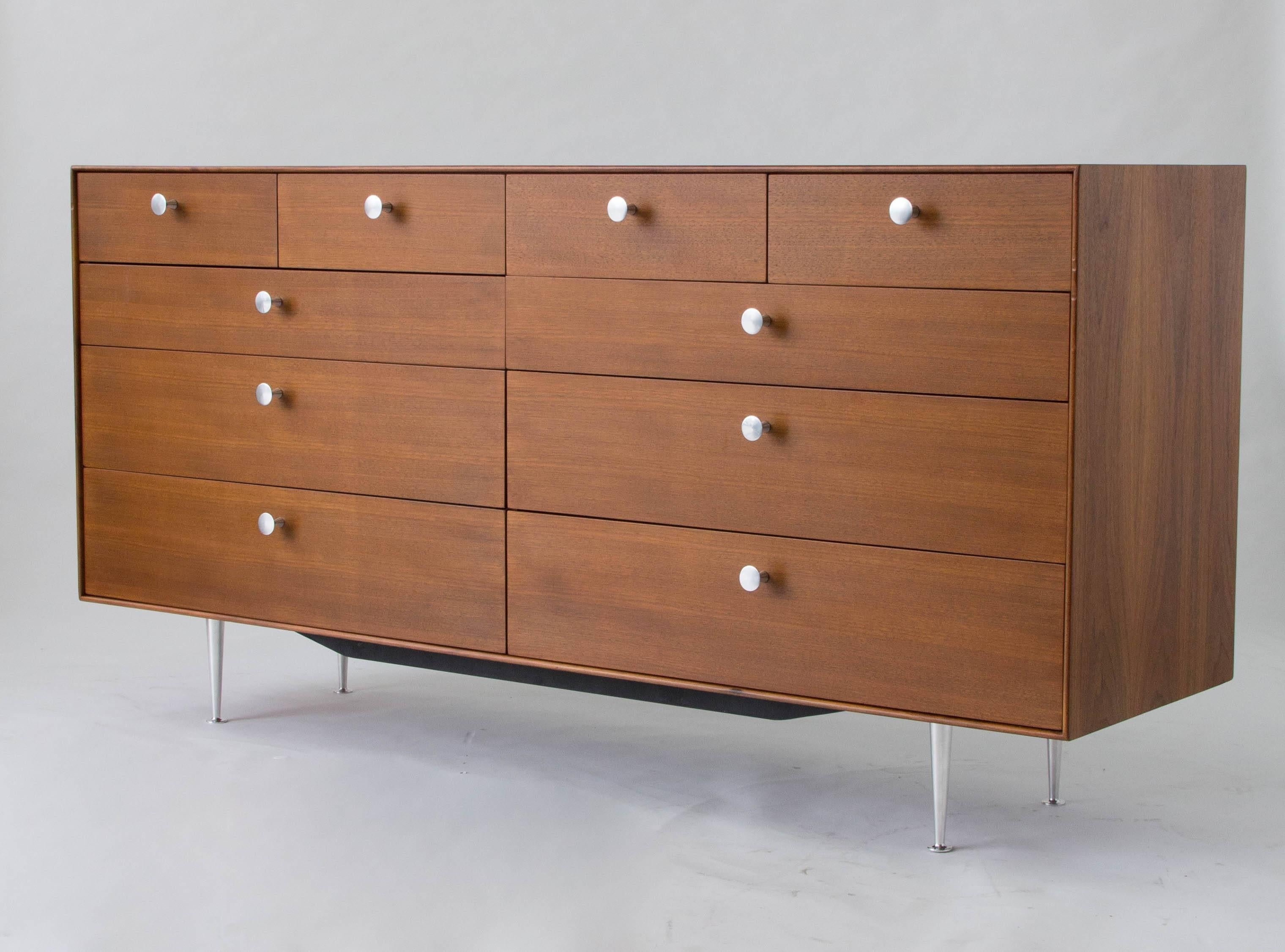 A ten-drawer double dresser from George Nelson’s Thin Edge collection for Herman Miller. Design features the slender walnut case for which the series was named and a double stack of drawers, each with three wide drawers and two smaller drawers. Each