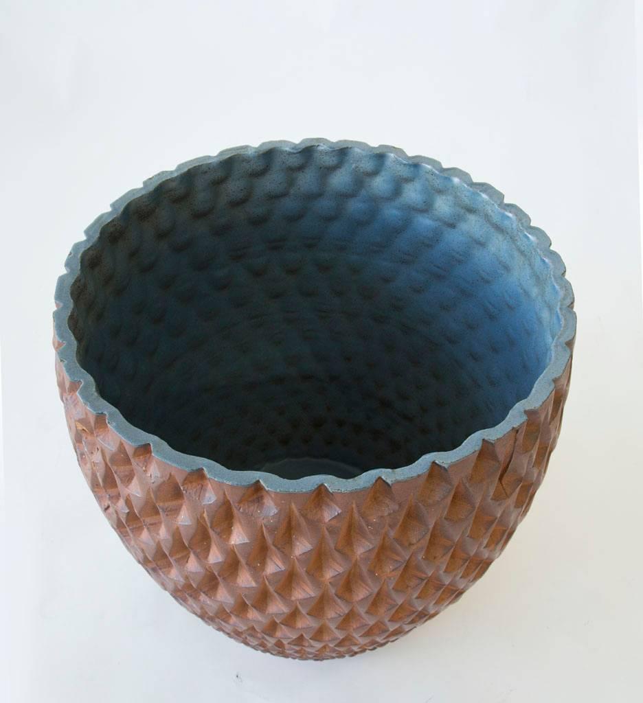 Designed by David Cressey in 1963 as part of his Pro/Artisan collection for Architectural Pottery, this Phoenix-two planter has a howl shape with geometric relief. The interior of the planter is glazed and has a stunning gradation of blue. The