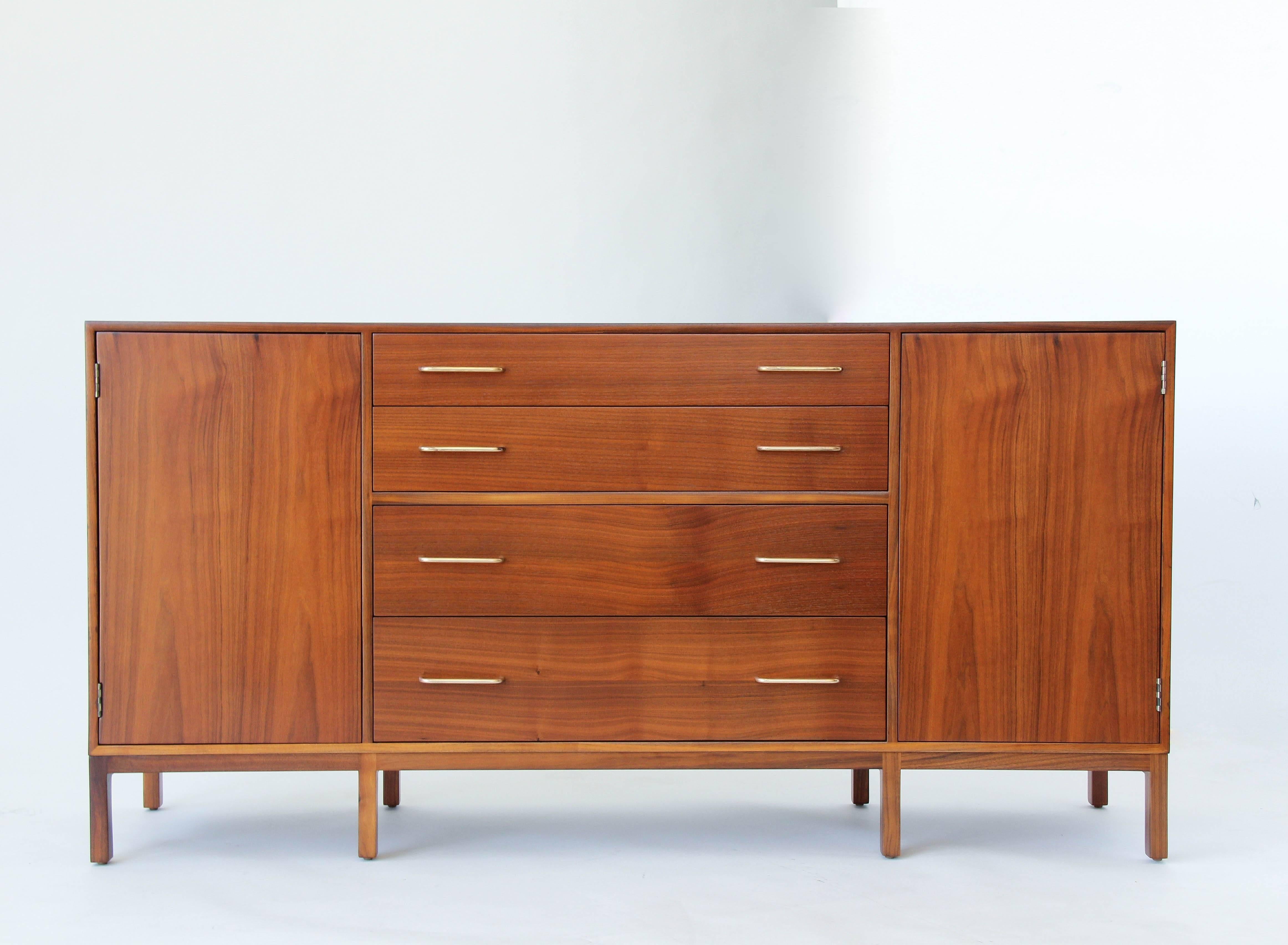 Rare sideboard or credenza designed by Edward Wormley for Dunbar. The mahogany case sits on an eight-legged frame and has two plain cabinet door with concealed push latch closures flanking four drawers with brass bar pulls. The uppermost drawer has