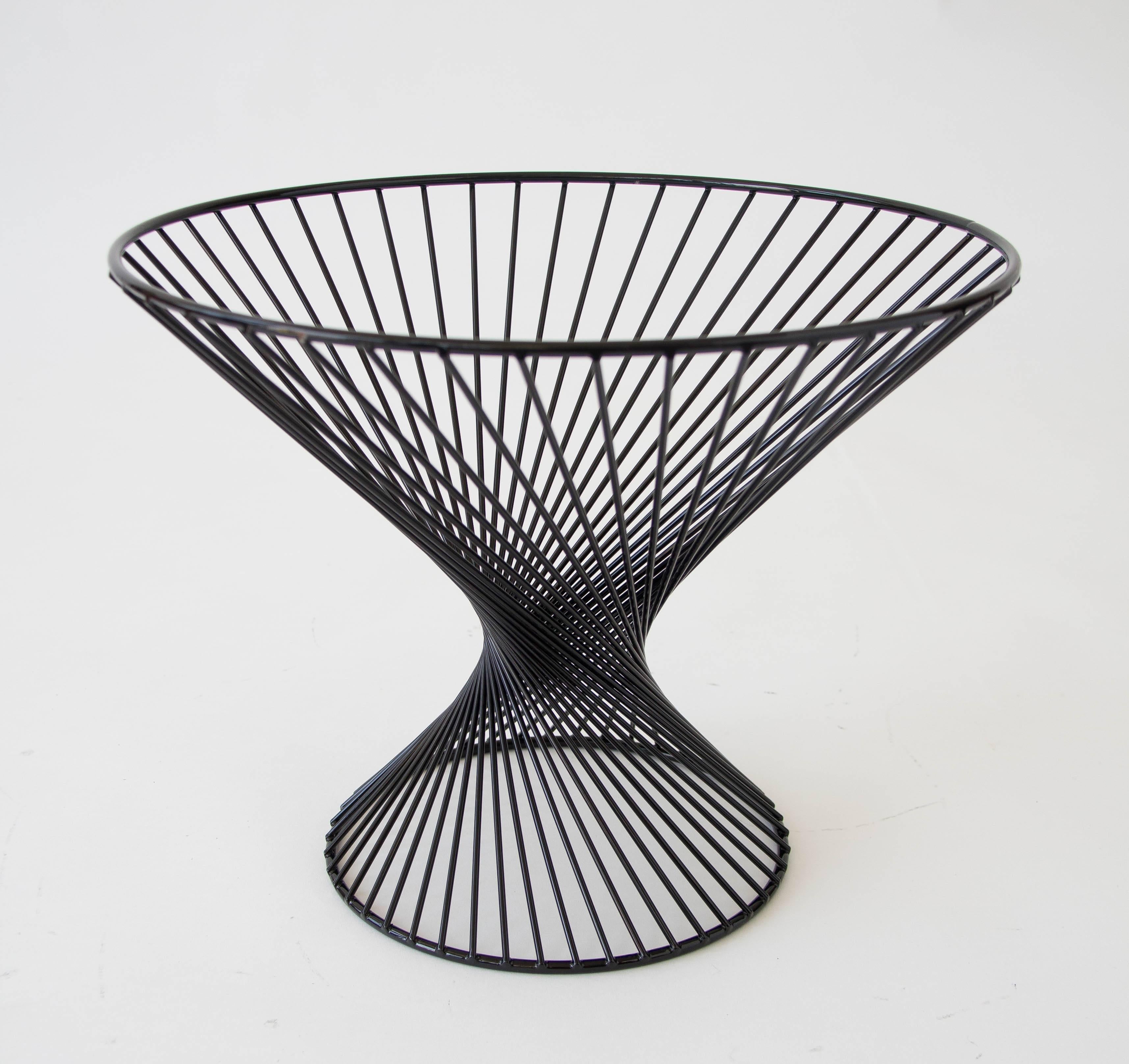 A powder-coated wire fruit basket The piece has an hourglass shape with rotated spokes forming a sculptural design. 

Condition: Excellent restored condition; professionally powder-coated. 

Dimension: 15