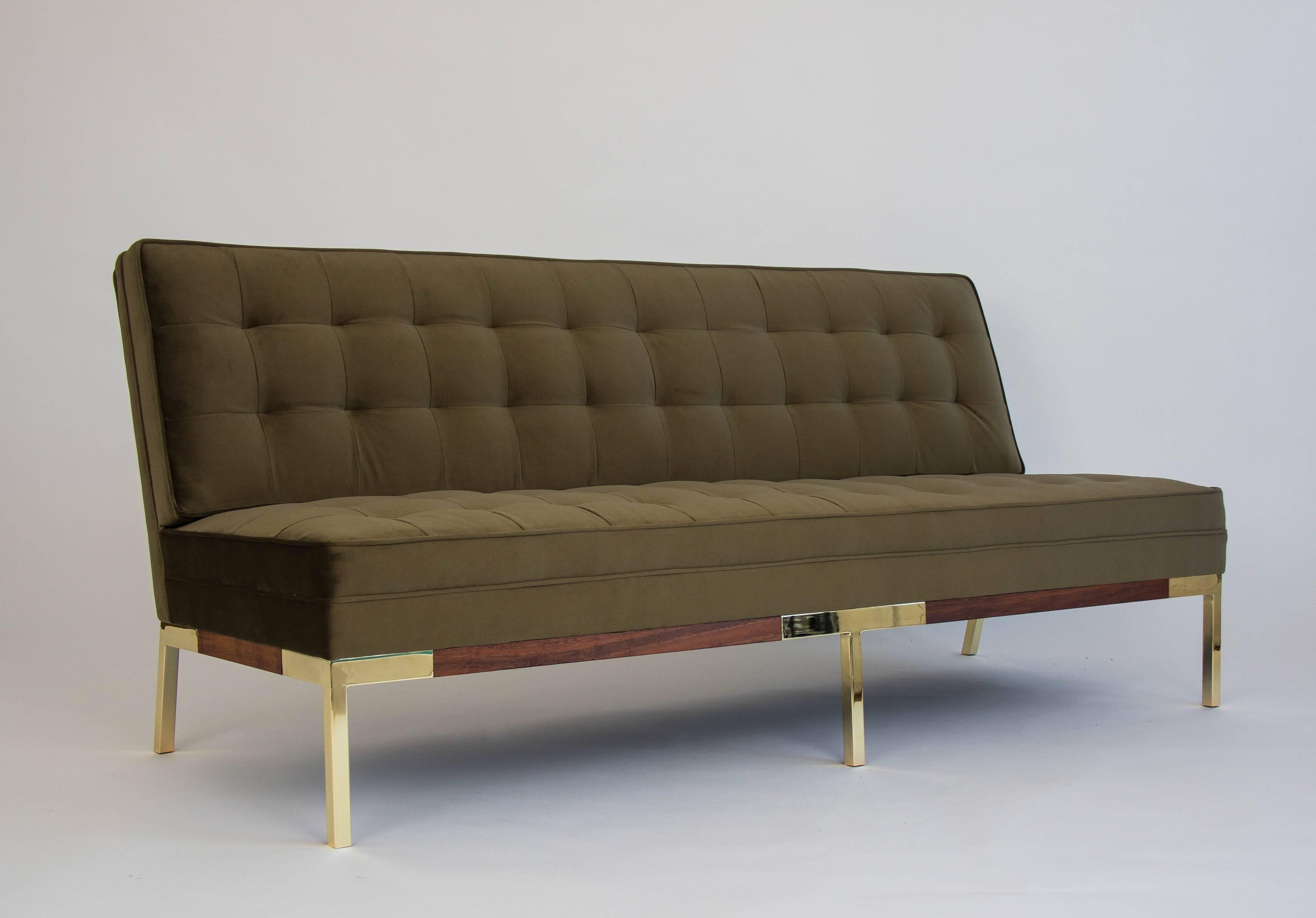 A fully restored sofa by Lee Woodard for Woodard Furniture has a three-seat design with integrated backrests and seat cushions. The olive green velvet upholstery is quilted according to the original design and welted corners emphasize the structured