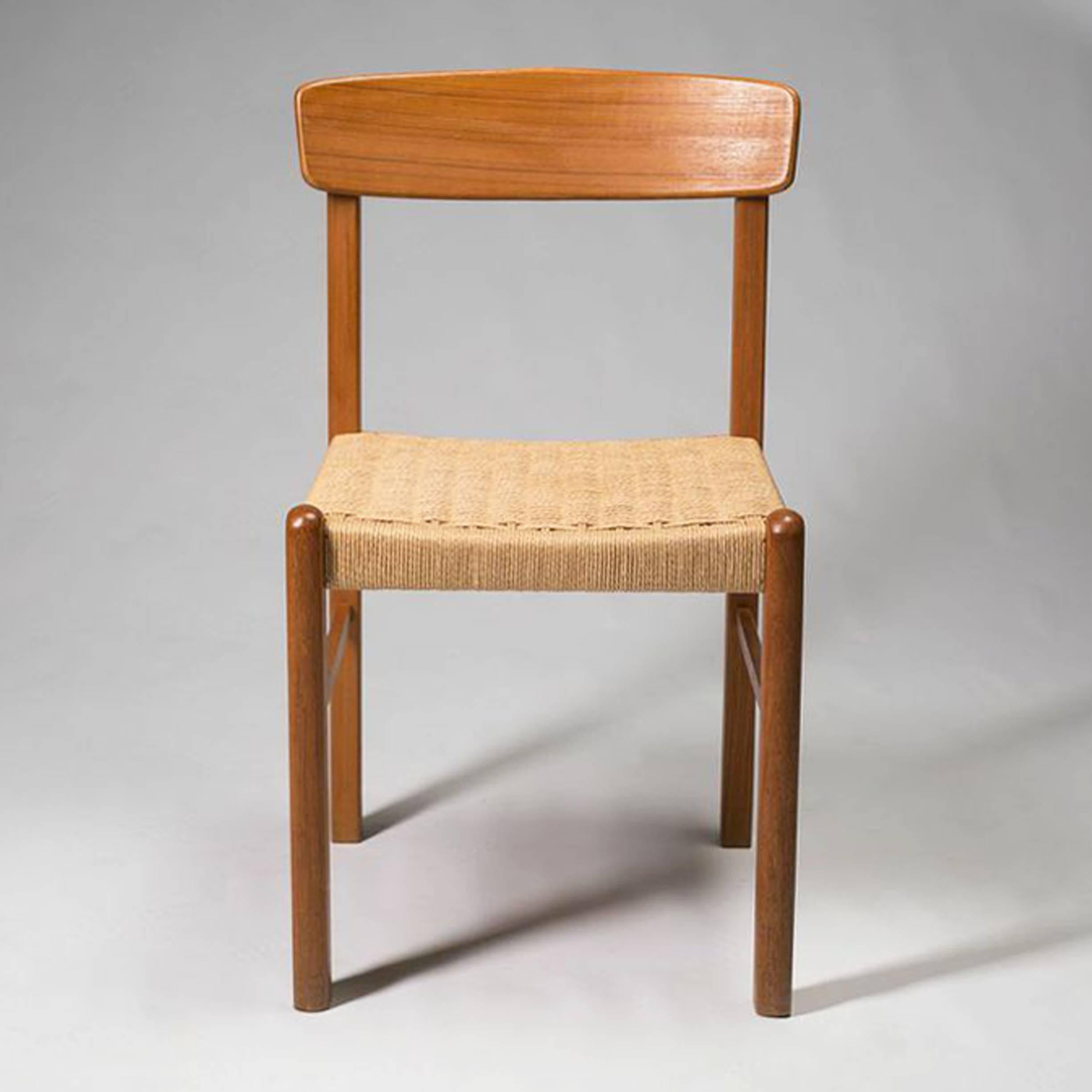 Danish modern teak dining chairs. Seats are woven papercord, a style made famous by Niels Møller. Made in Thailand. Many Danish modern furniture manufacturing moved production in South Asia in latter decades to get closer to the teak resources.