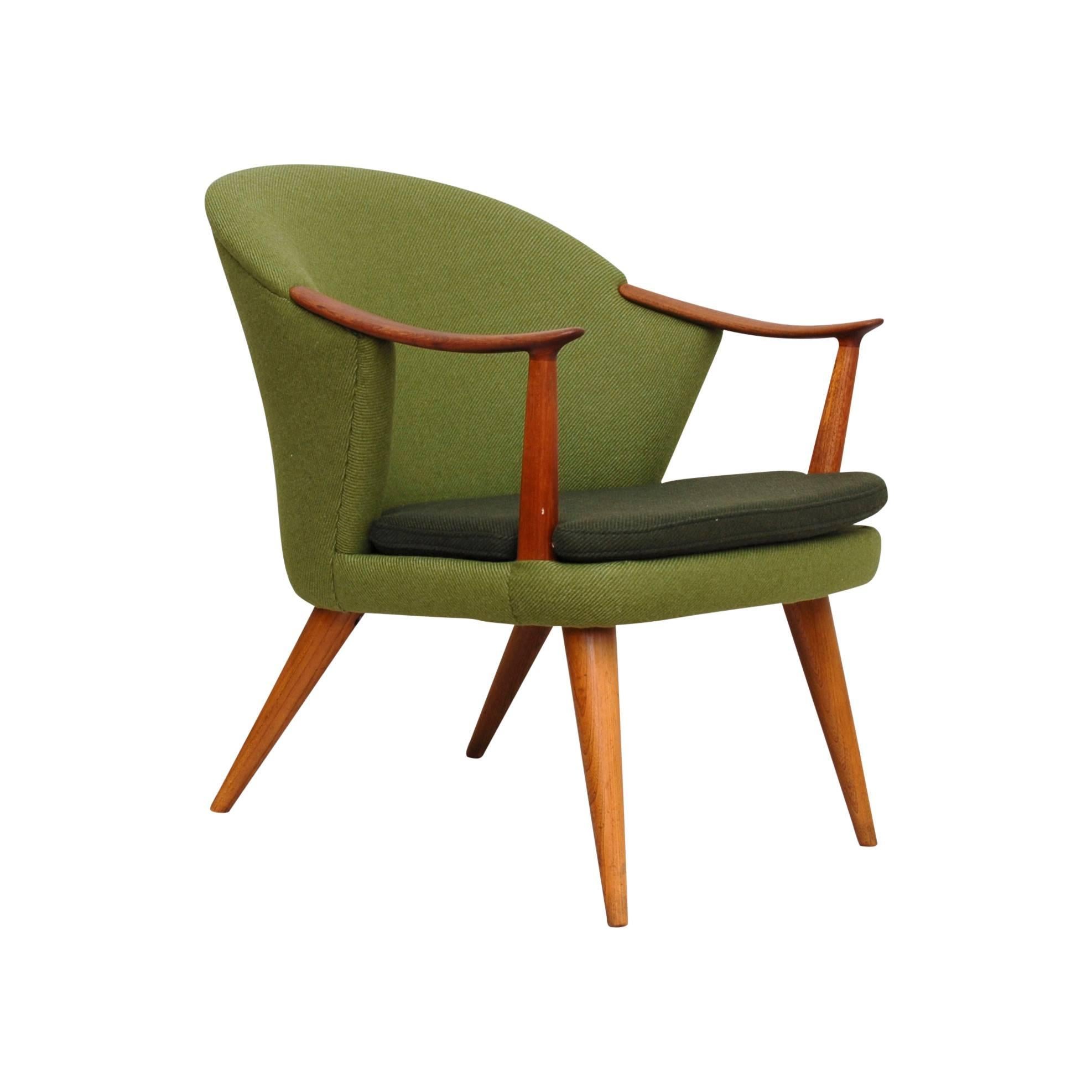 Great armchairs in Teak designed by Norwegian designer Per Langlo for his own manufacture in Stranda Norway. Newly upholstered with Wool from Norwegian manufacturer Gudbransdalen Ullvarefabrikk. Woodwork in oiled teak. 
