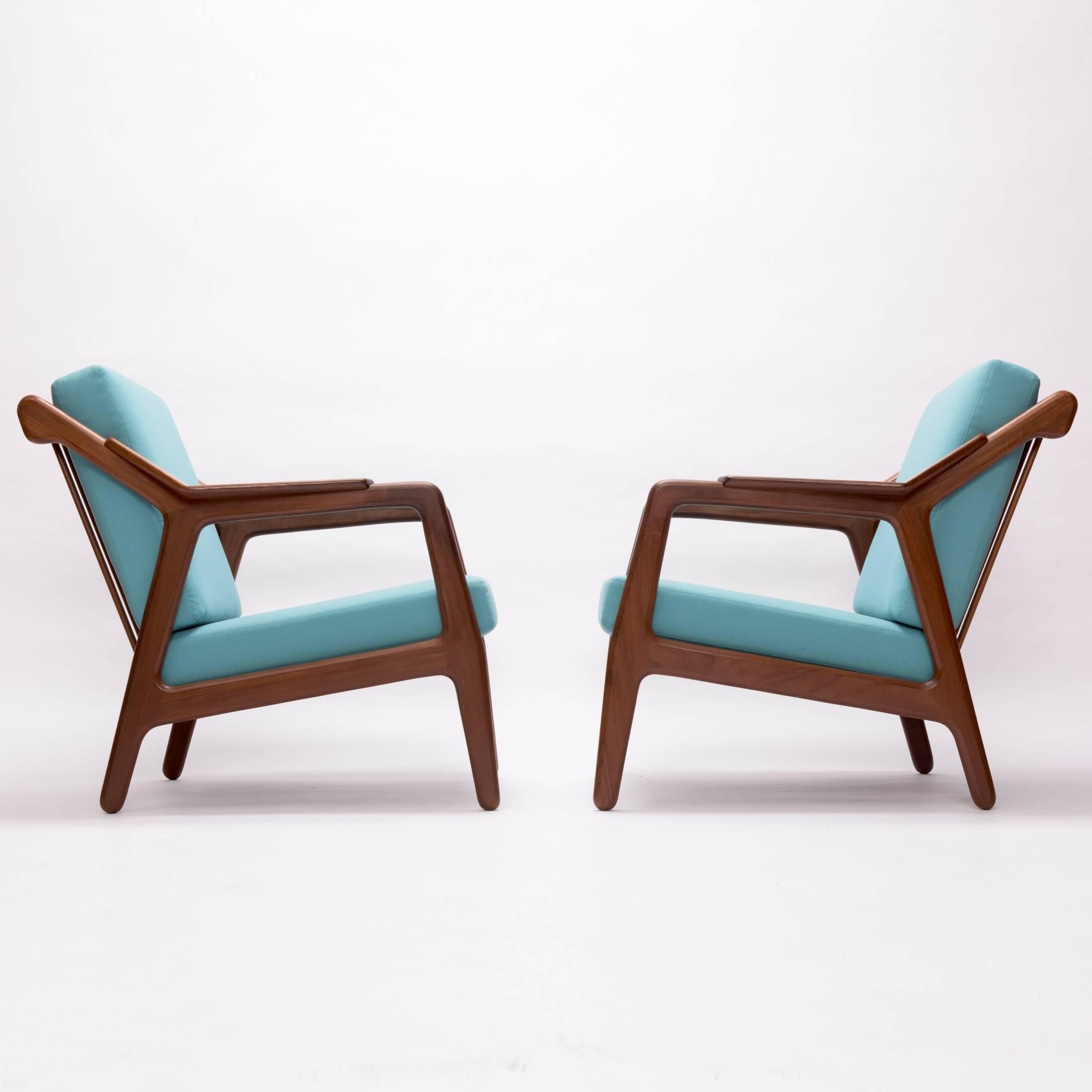 Gorgeous pair of teak easy chairs, designed 1955, with exposed teak frame and loose cushions in soft turquoise.
Designer: H. Brockmann Petersen.
Manufacturer: Randers Møbler, Denmark.
Excellent vintage condition, re-upholstered in high quality