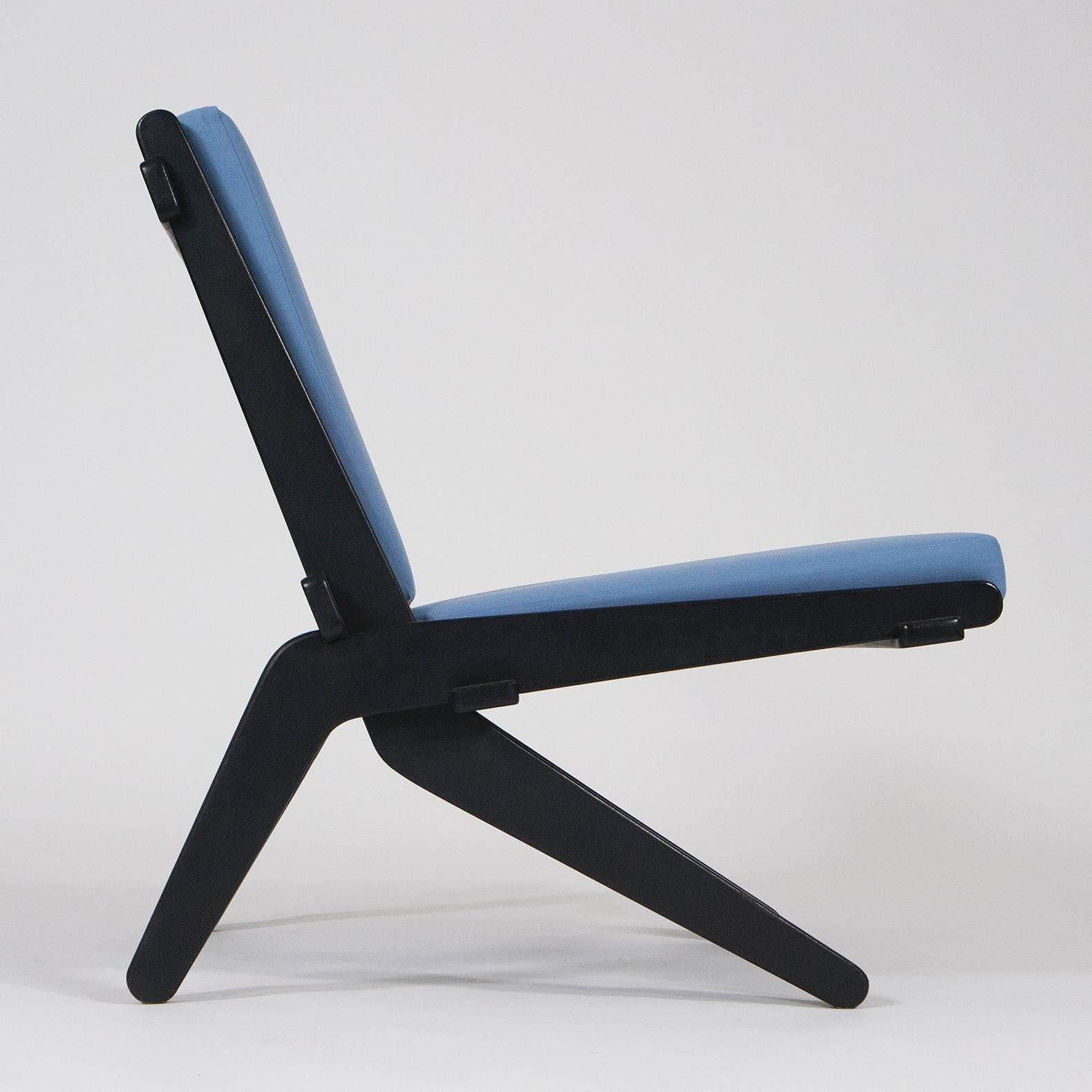 Mid-Century Modern lounge chair. Minimalistic Scandinavian Design from the 1950s. Futuristic construction, black lacquered wood, completely restored, new cushions with high quality powder blue fabric.