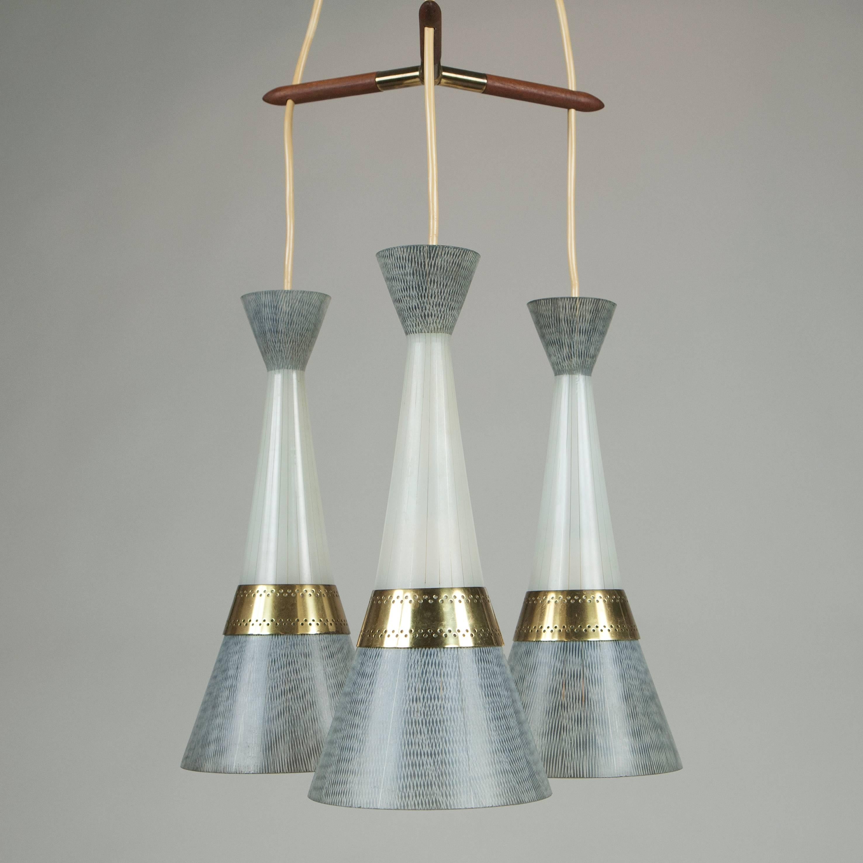 Magnificent Stilnovo style brass chandelier with fine glass shades and triangular teak element. Very rare graphic Mid-Century Modern Design from the Italian, circa 1958